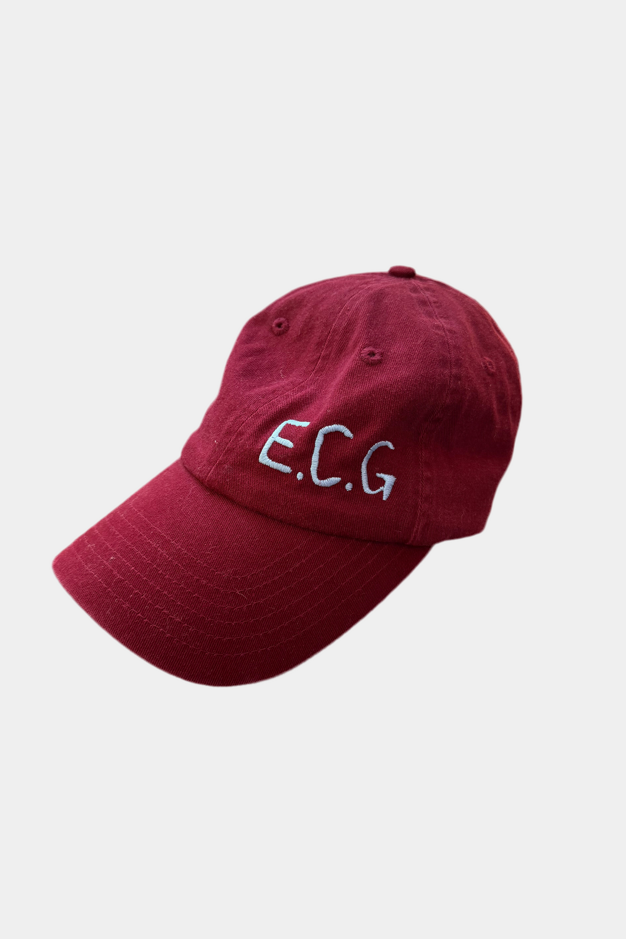 Burgundy cap with 'E.C.G.' embroidery on a white background