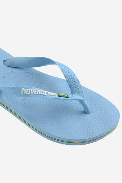 Light blue flip-flop sandal with 'havaianas' logo on a white background