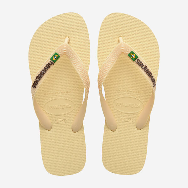 Pair of beige flip-flops with brand logo on a light gray background