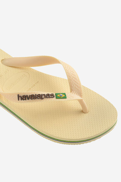 Yellow sandal with Havaianas logo on a white background