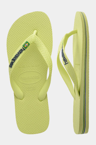 Pair of lime green flip-flops with brand logo on a white background