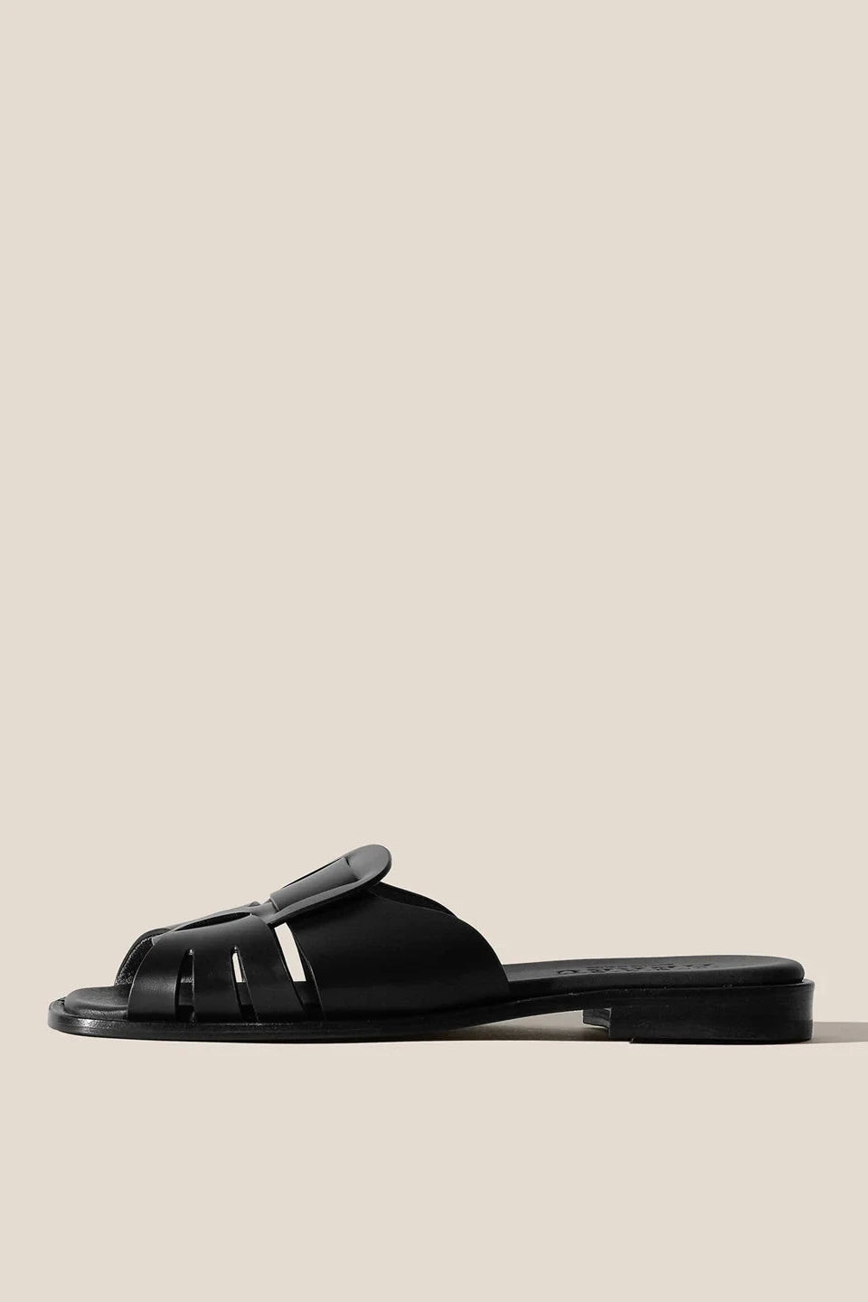 Black sandal on a beige background