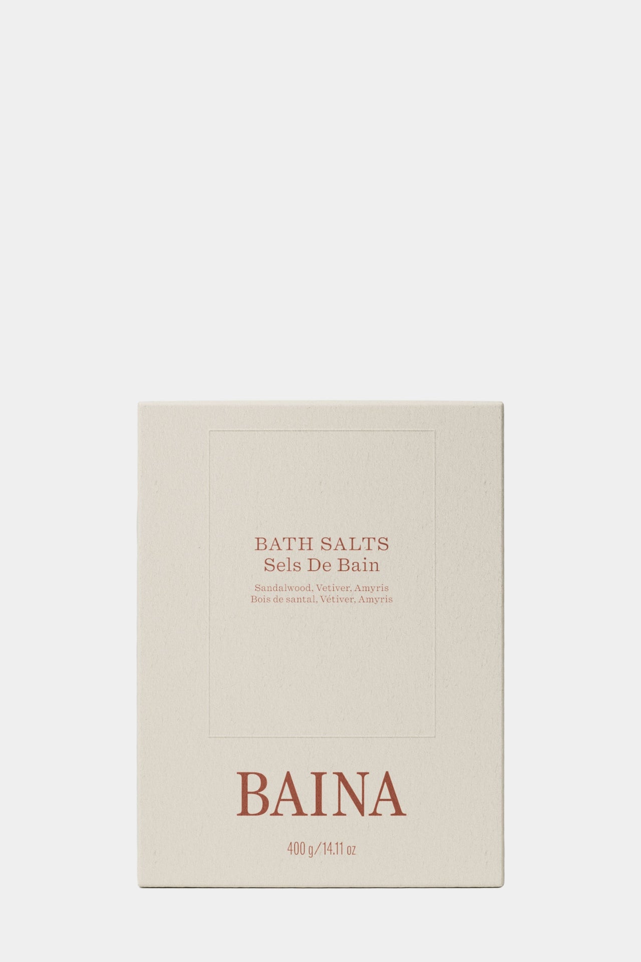Silver container of BAINA bath salts on a gray background