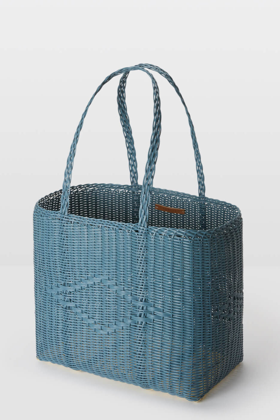 Blue woven handbag on a white background