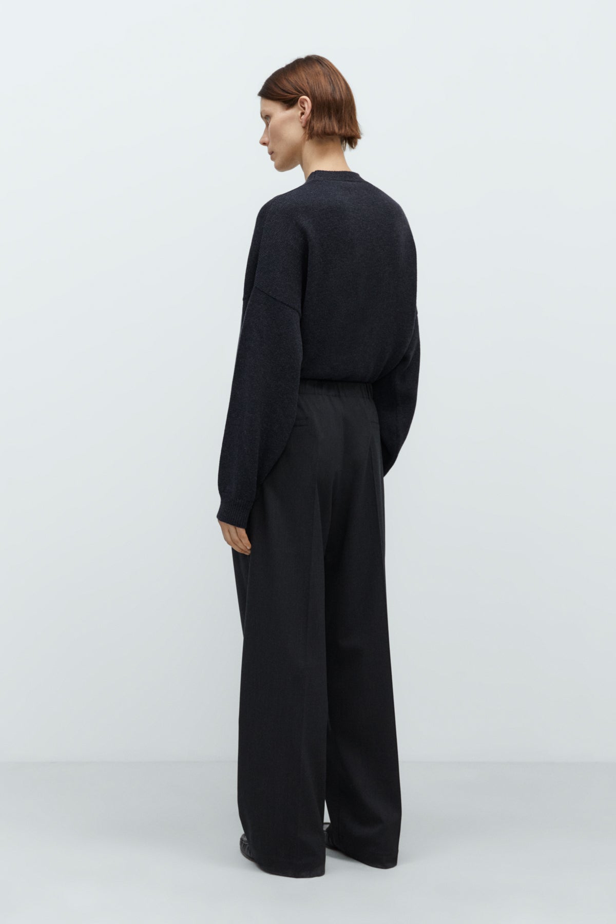 Person wearing a black outfit on a white background