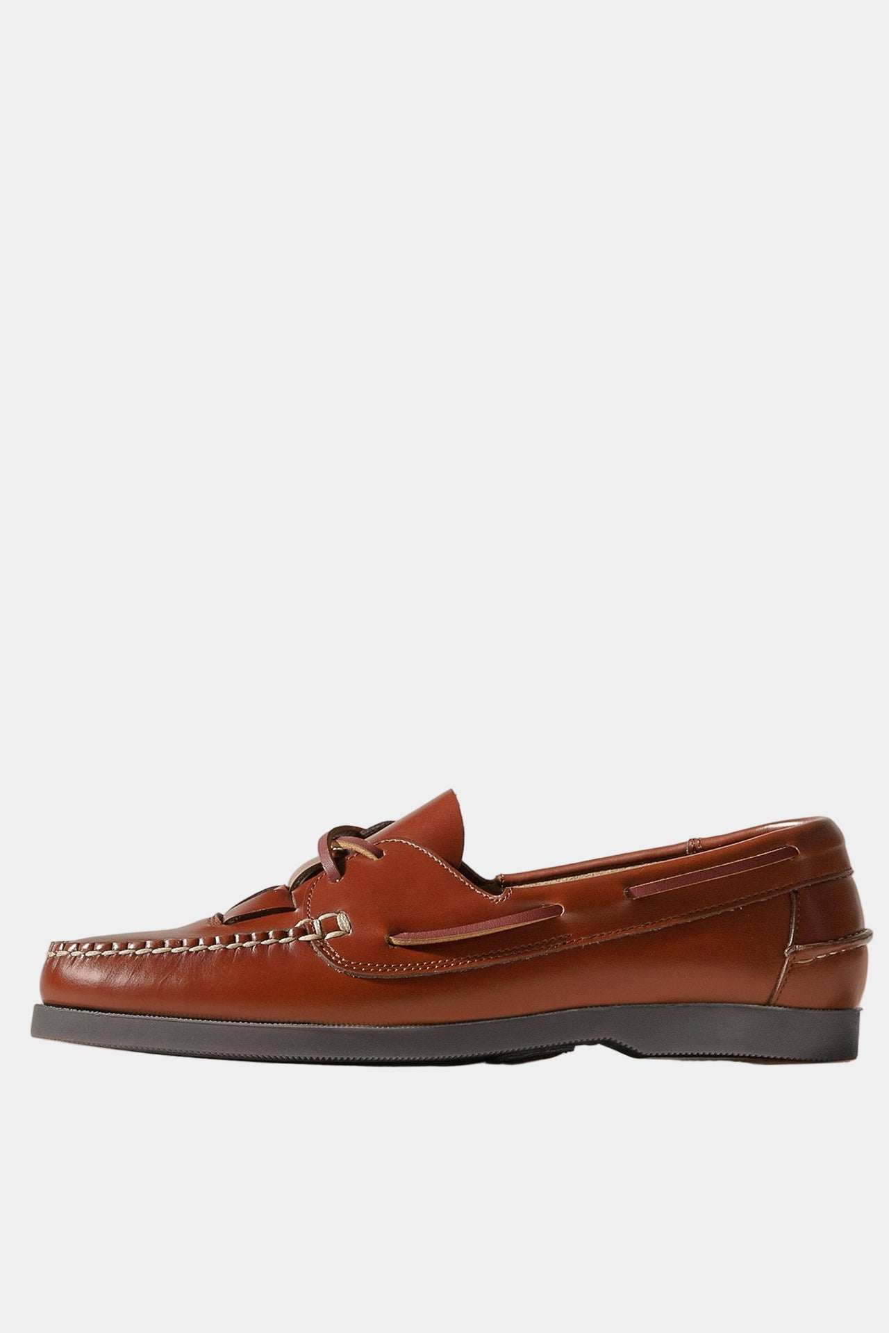 Pair of brown leather loafers with Hereu branding on a white background