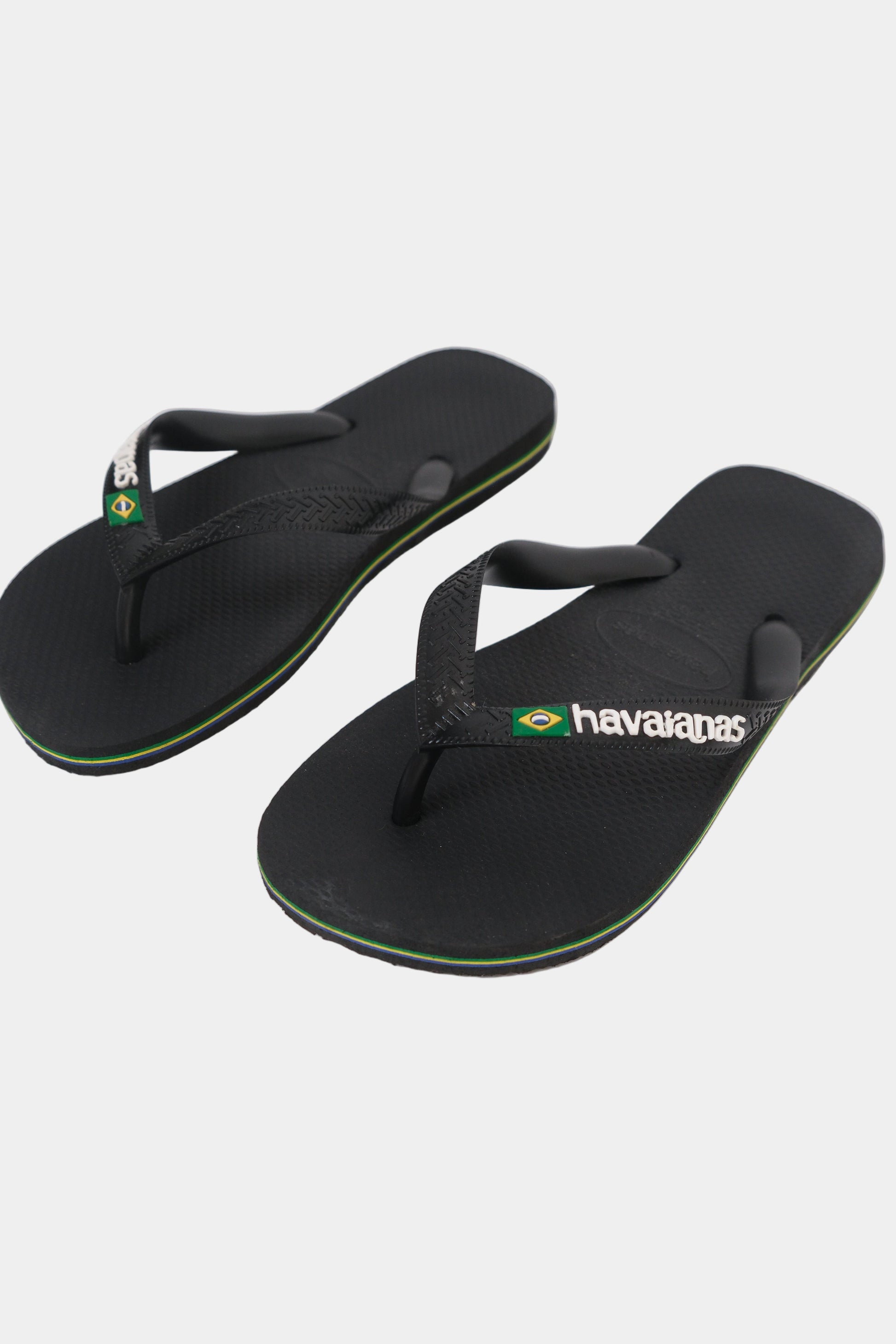 Black Havaianas flip-flops on a white background