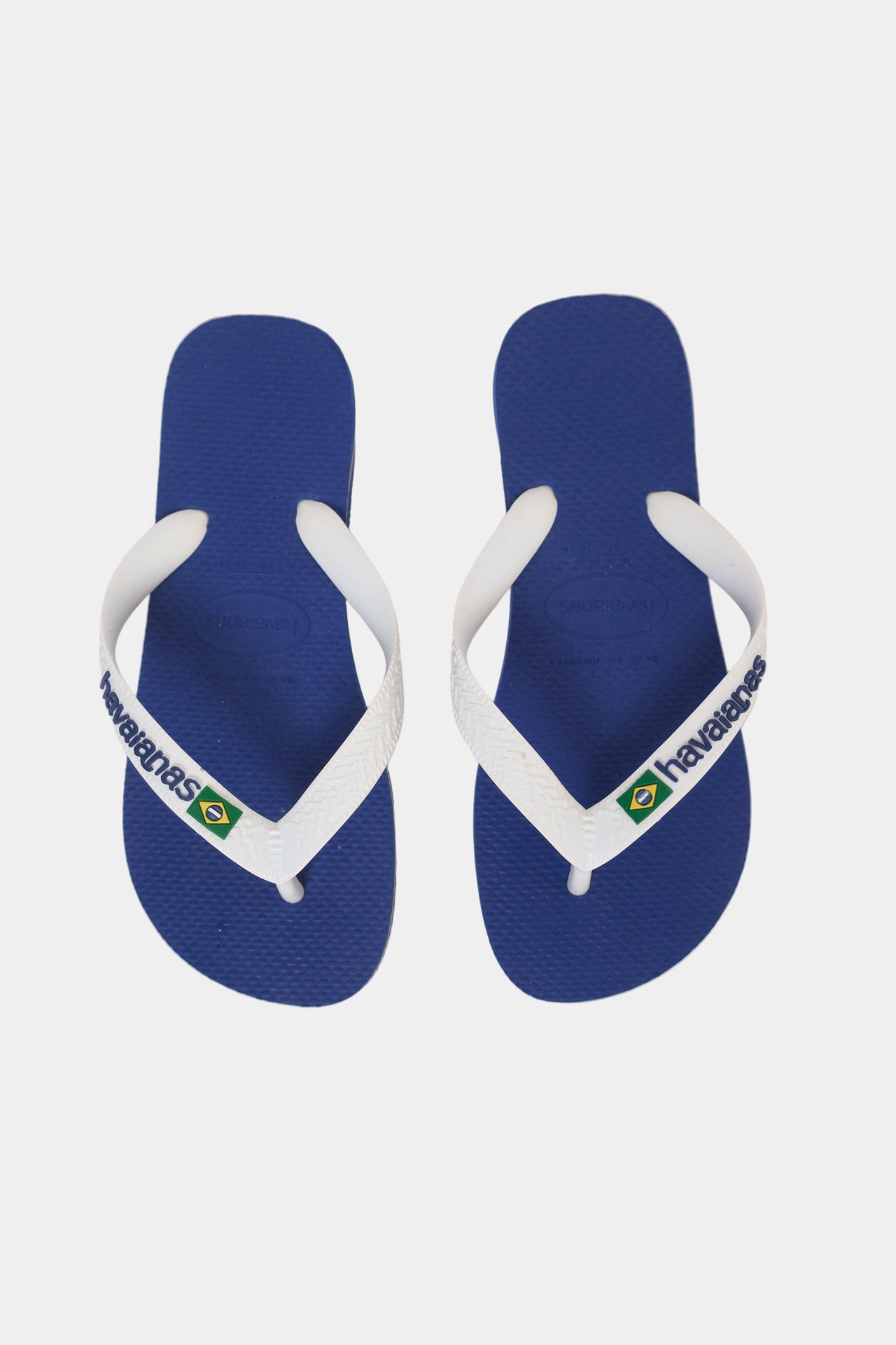 A pair of blue and white Havaianas flip-flops displayed against a white background.