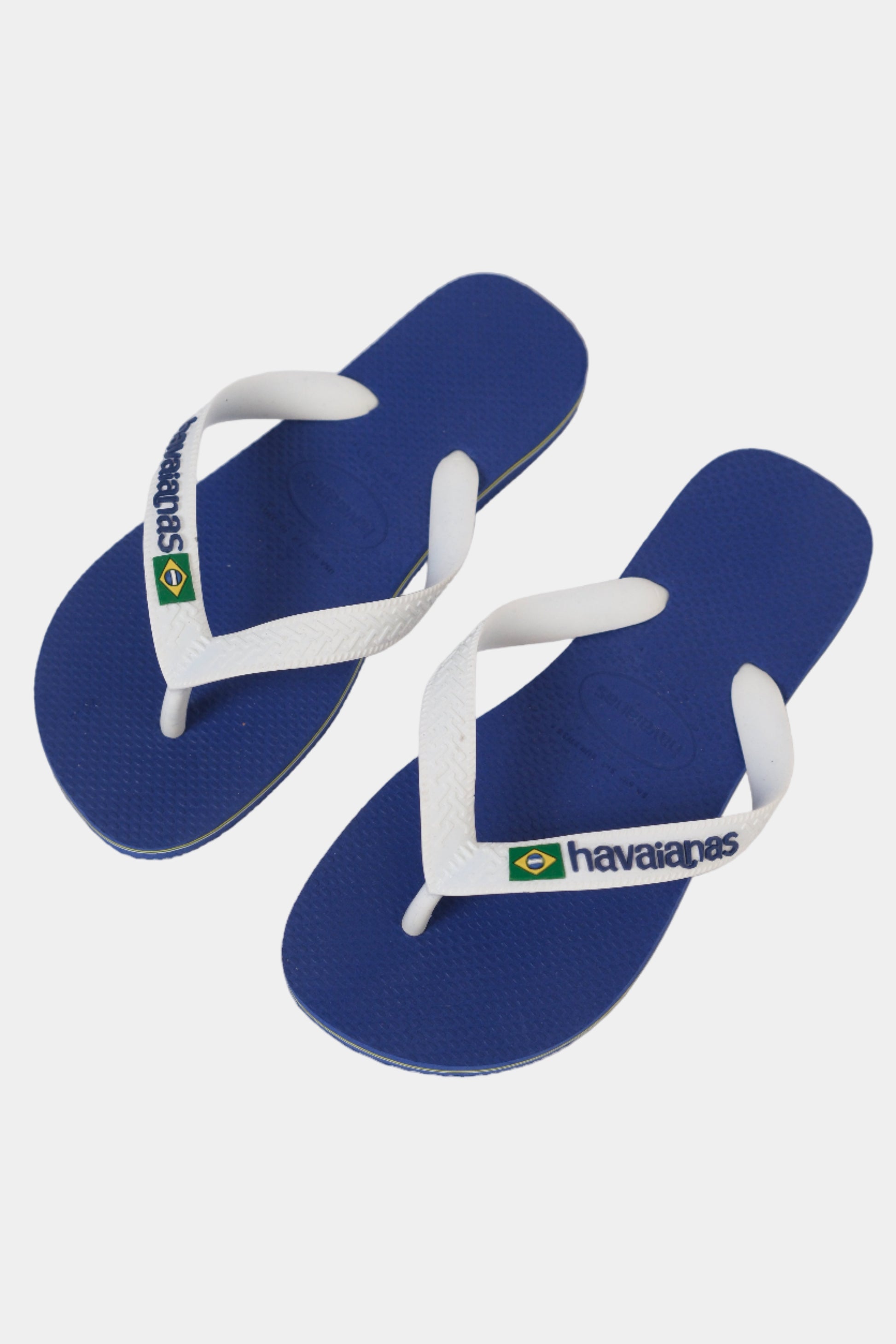 Blue and white Havaianas flip-flops on a light gray background