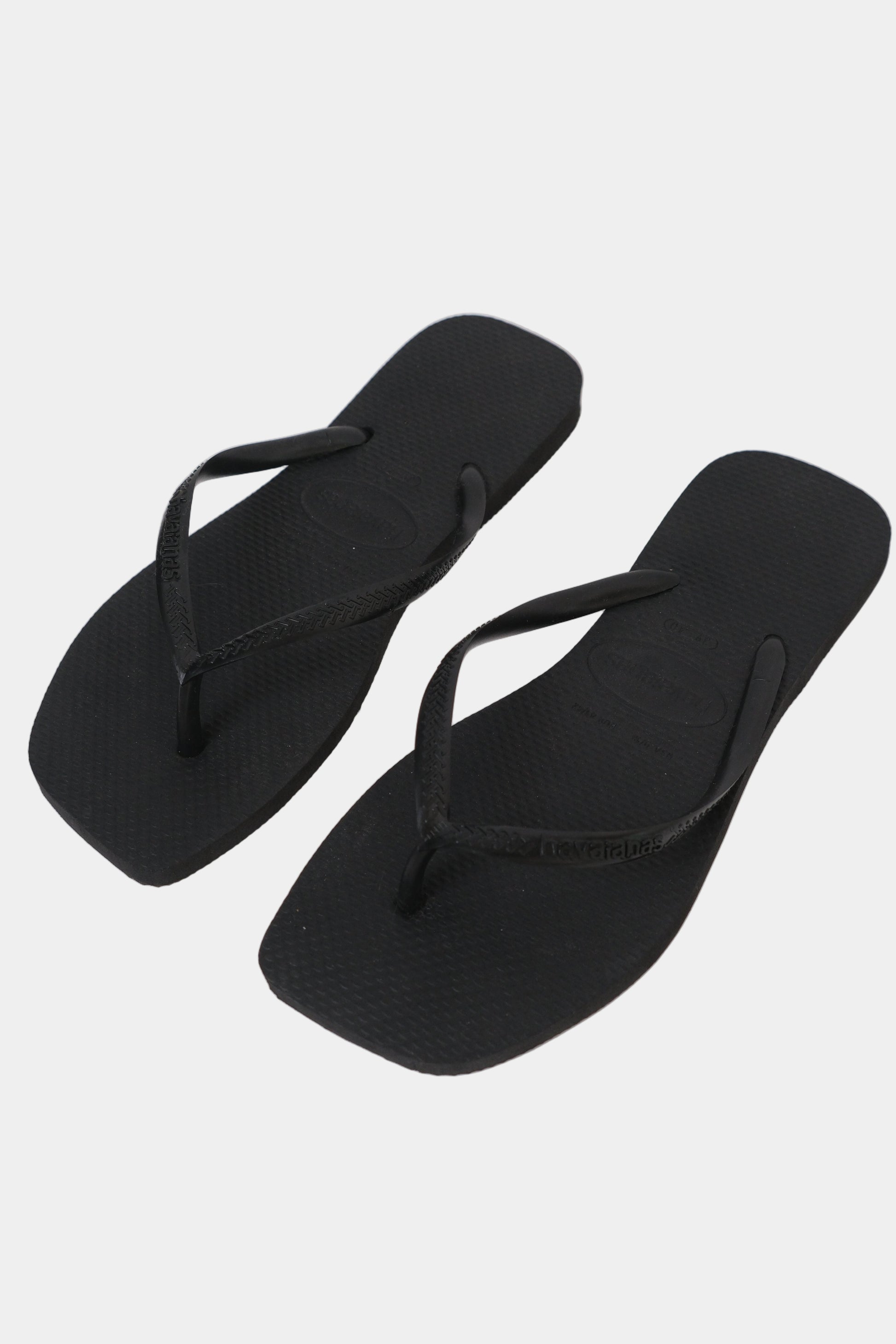 A pair of black Havaianas flip-flops with a square toe shape and slim strap.