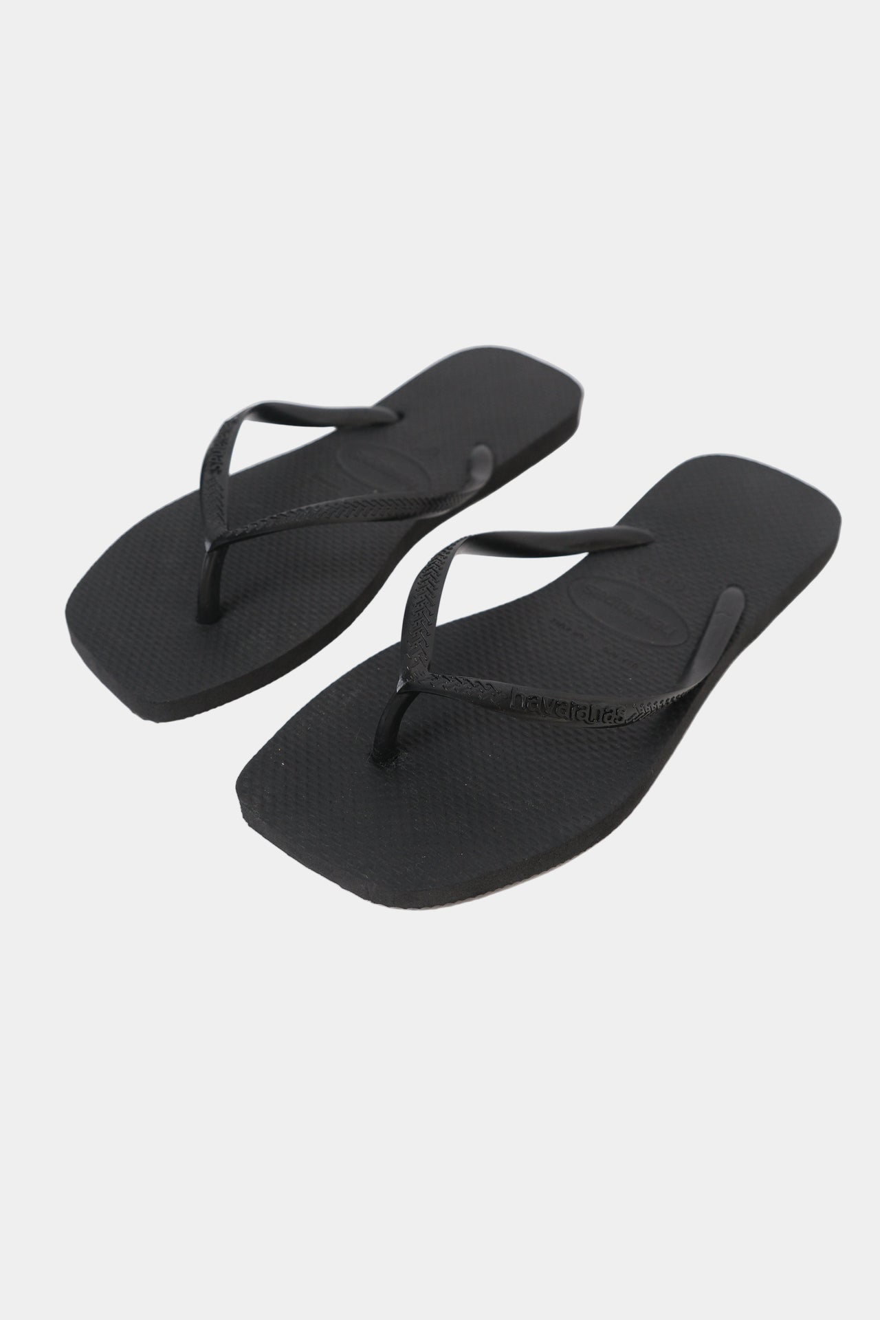 A pair of black Havaianas flip-flops with a square toe shape and slim strap.