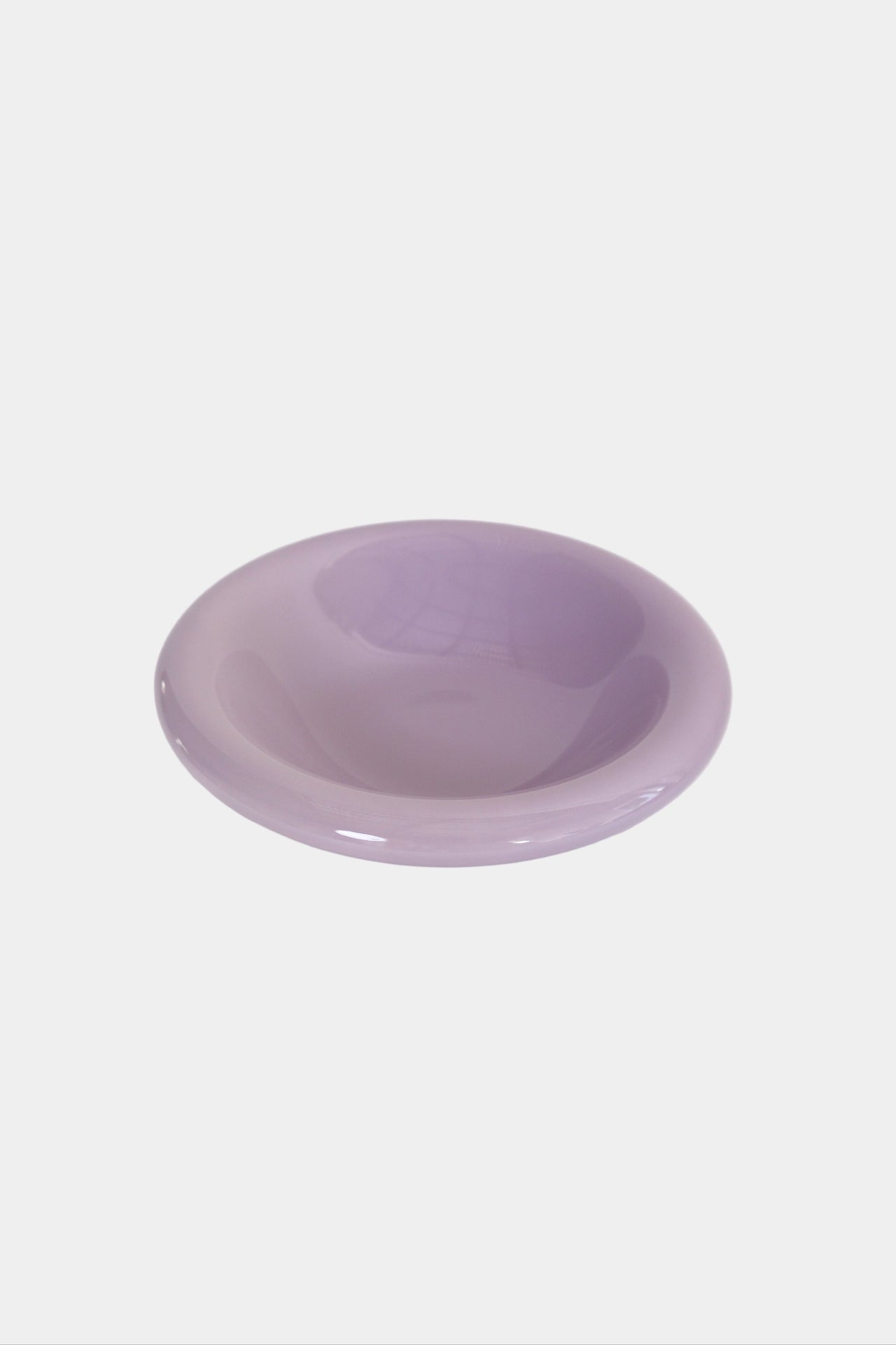 side bowl in lilac with a sponge inside sitting on a cream sink with brass tap