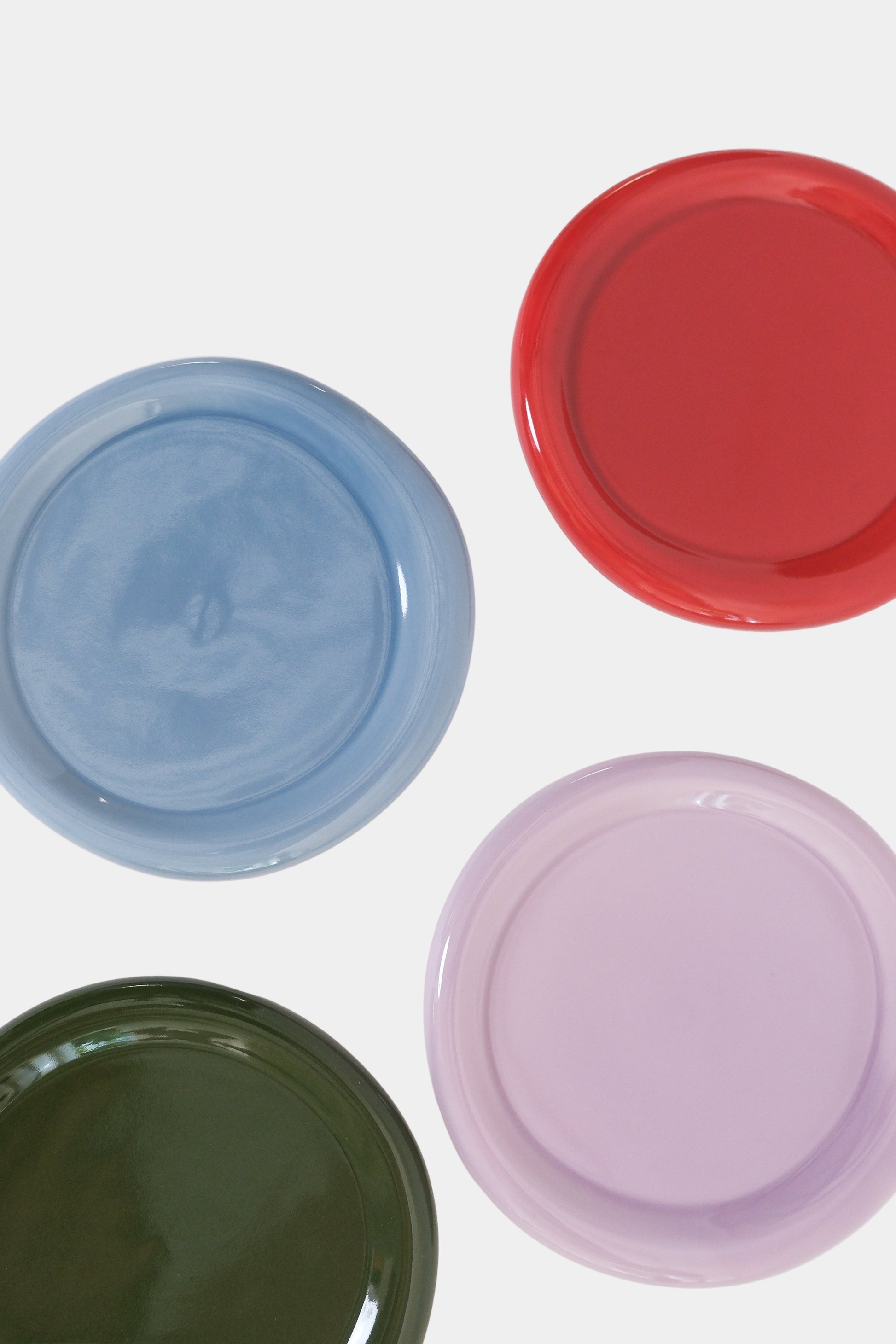 assortment on snack plates in green, blue, red, lilac on a white background