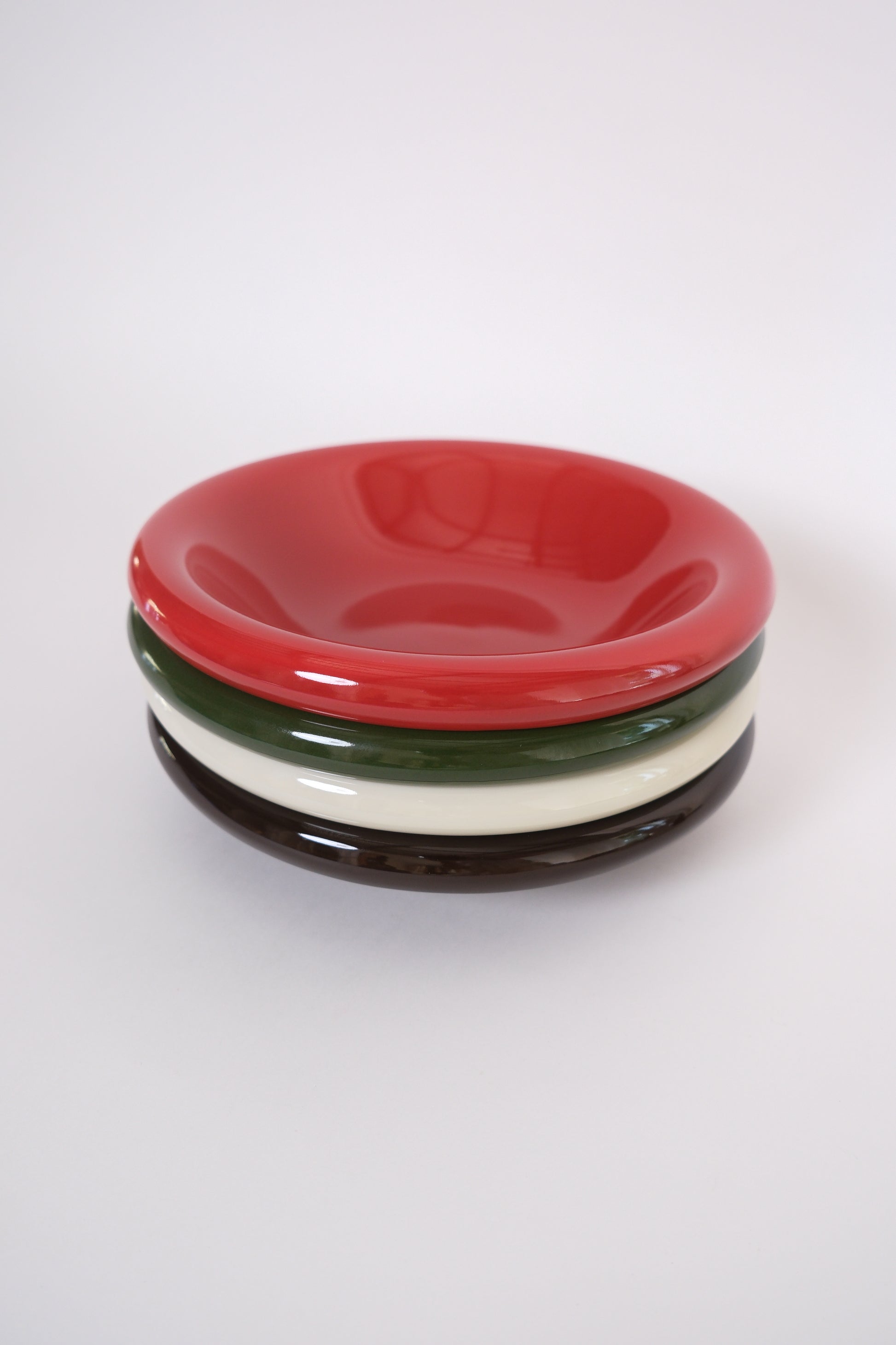 a stack of Everything Bowl in Marshmallow, tomato red, green and brown