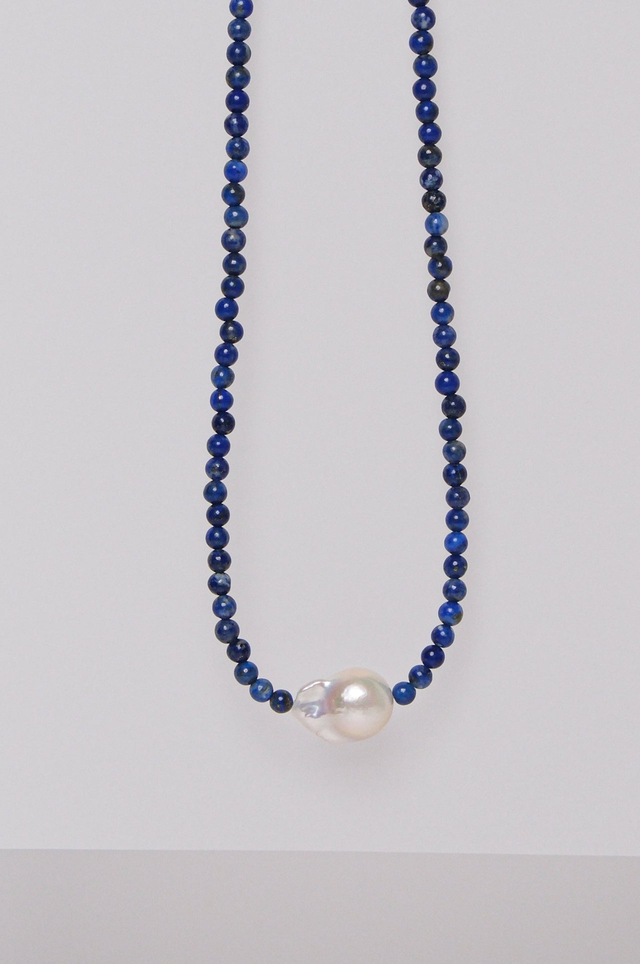 lapis beaded necklace with central single baroque pearl