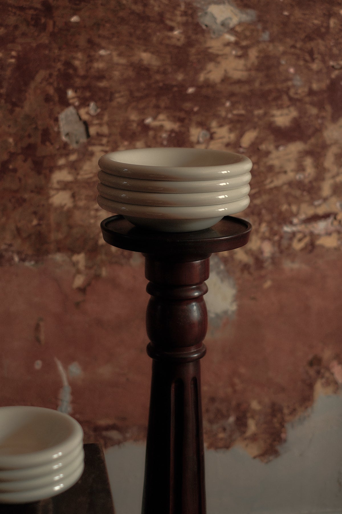 stack of cream coloured everything bowls displayed on a wooden pedestal