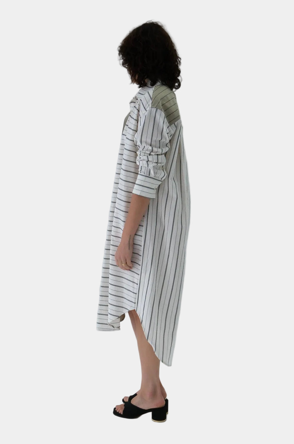 Woman wearing a striped dress with a plain background