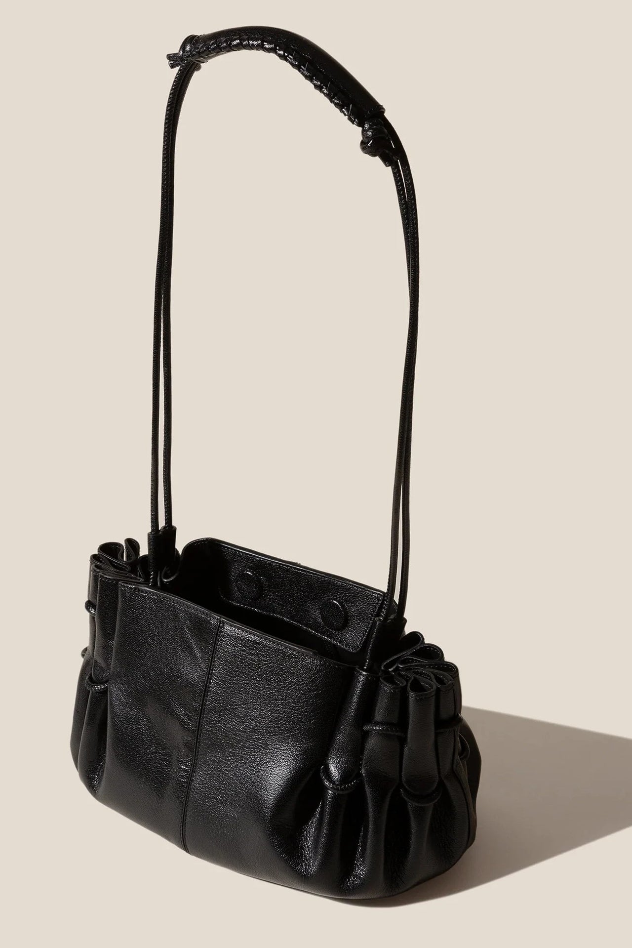 Black handbag on a beige background