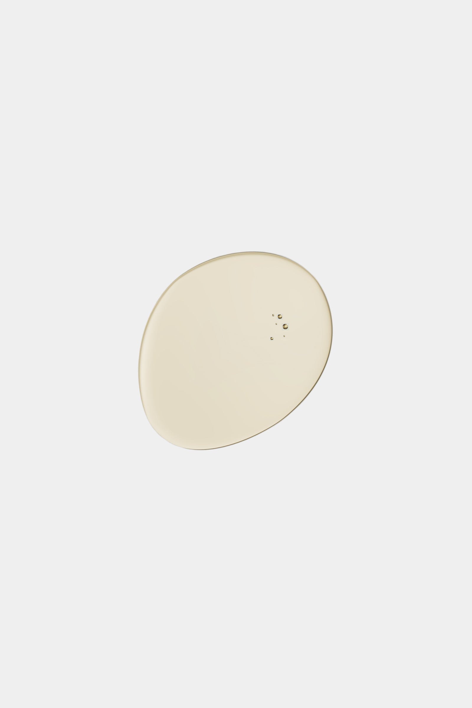 Round beige object on a gray background