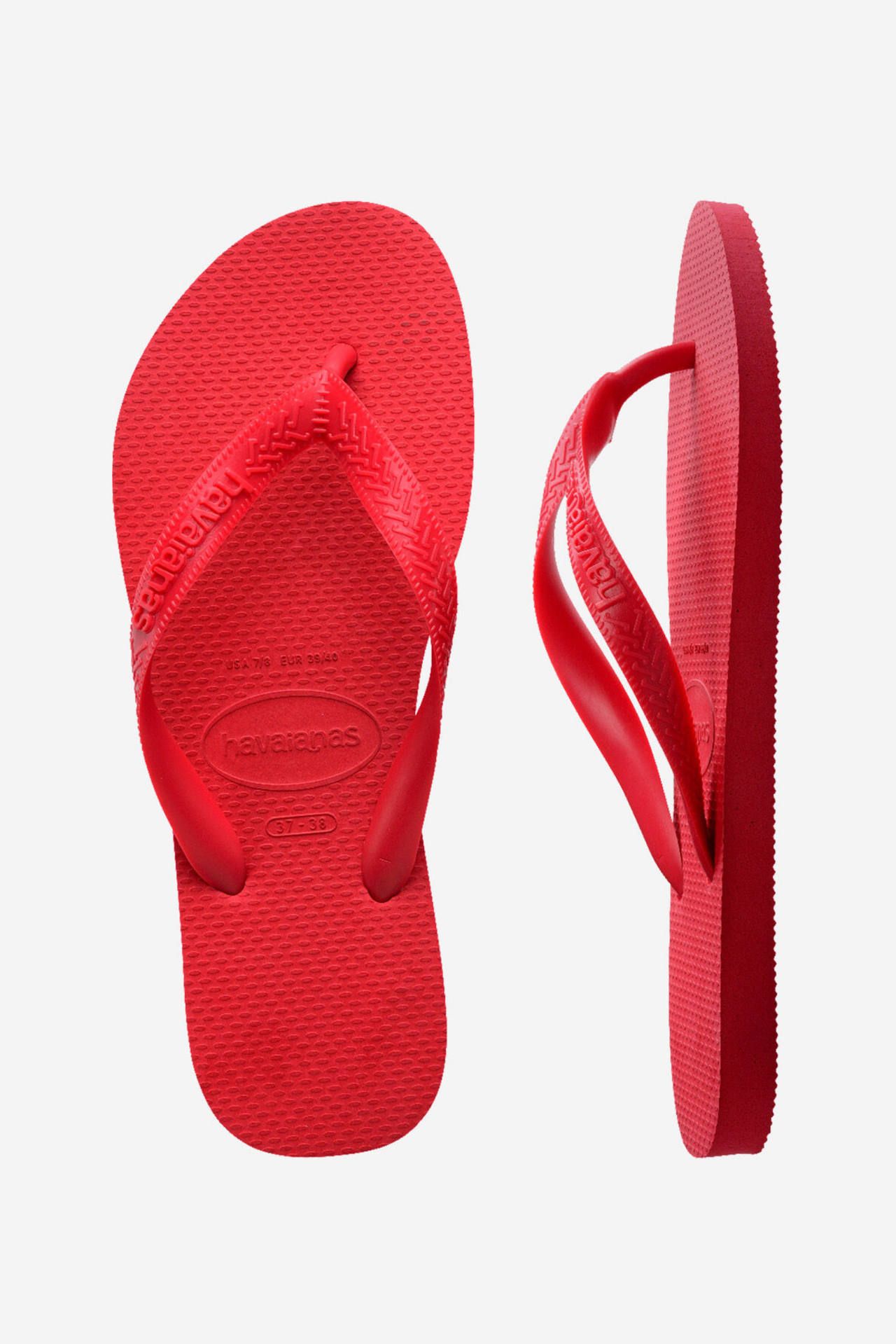 Red flip-flops with a visible brand logo on a light gray background