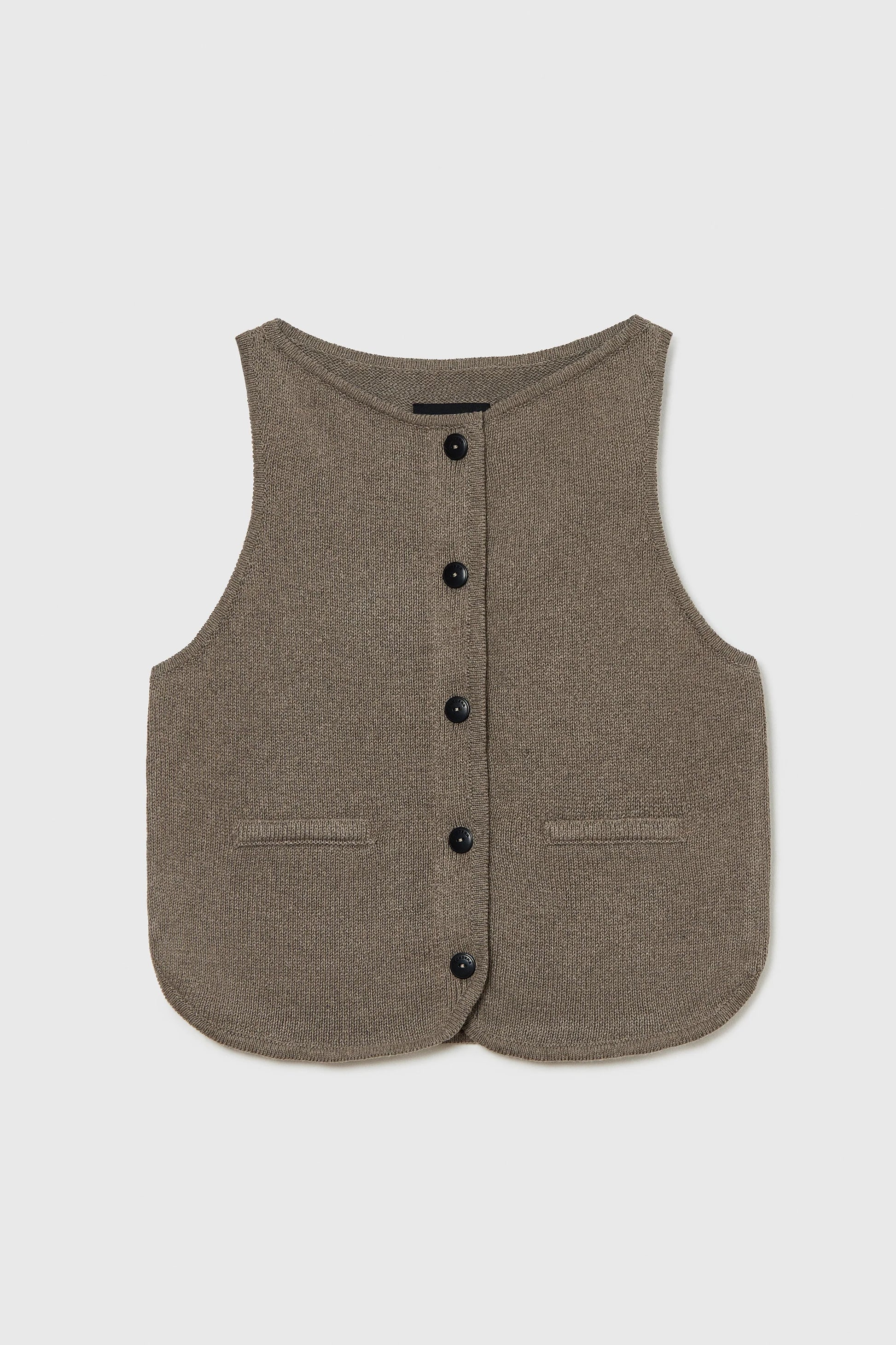Brown vest with button details on a light gray background