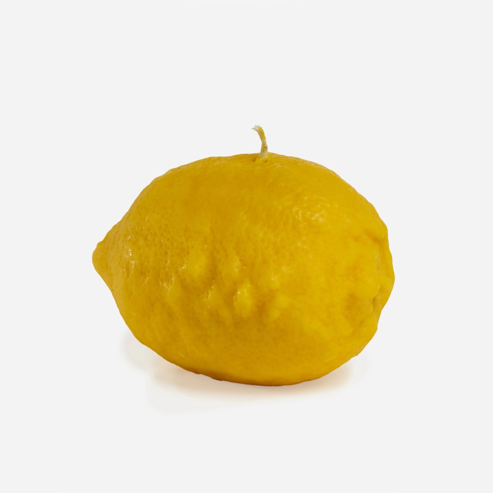 Yellow lemon candle on a white background