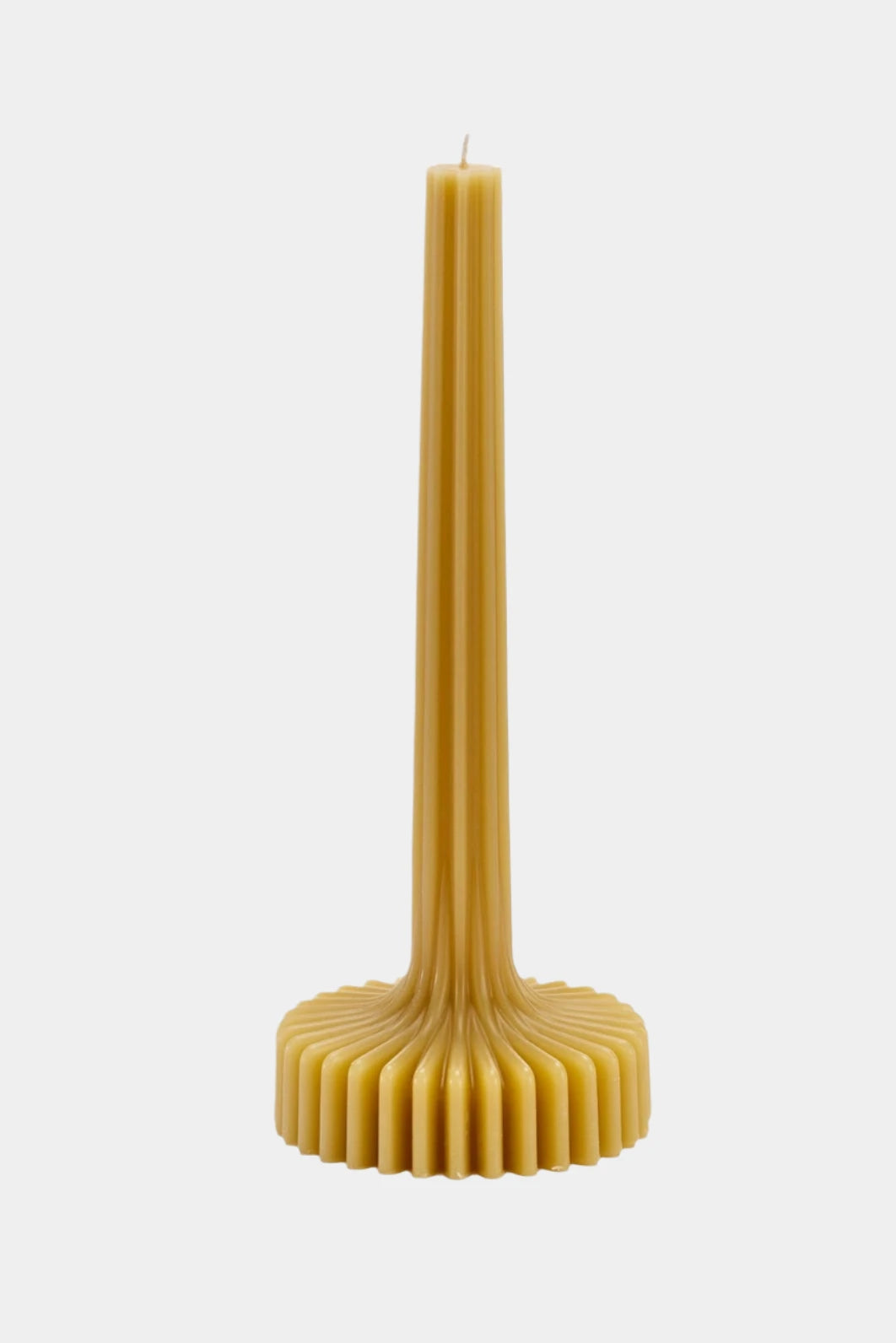 Ribbed beeswax candle on white background.