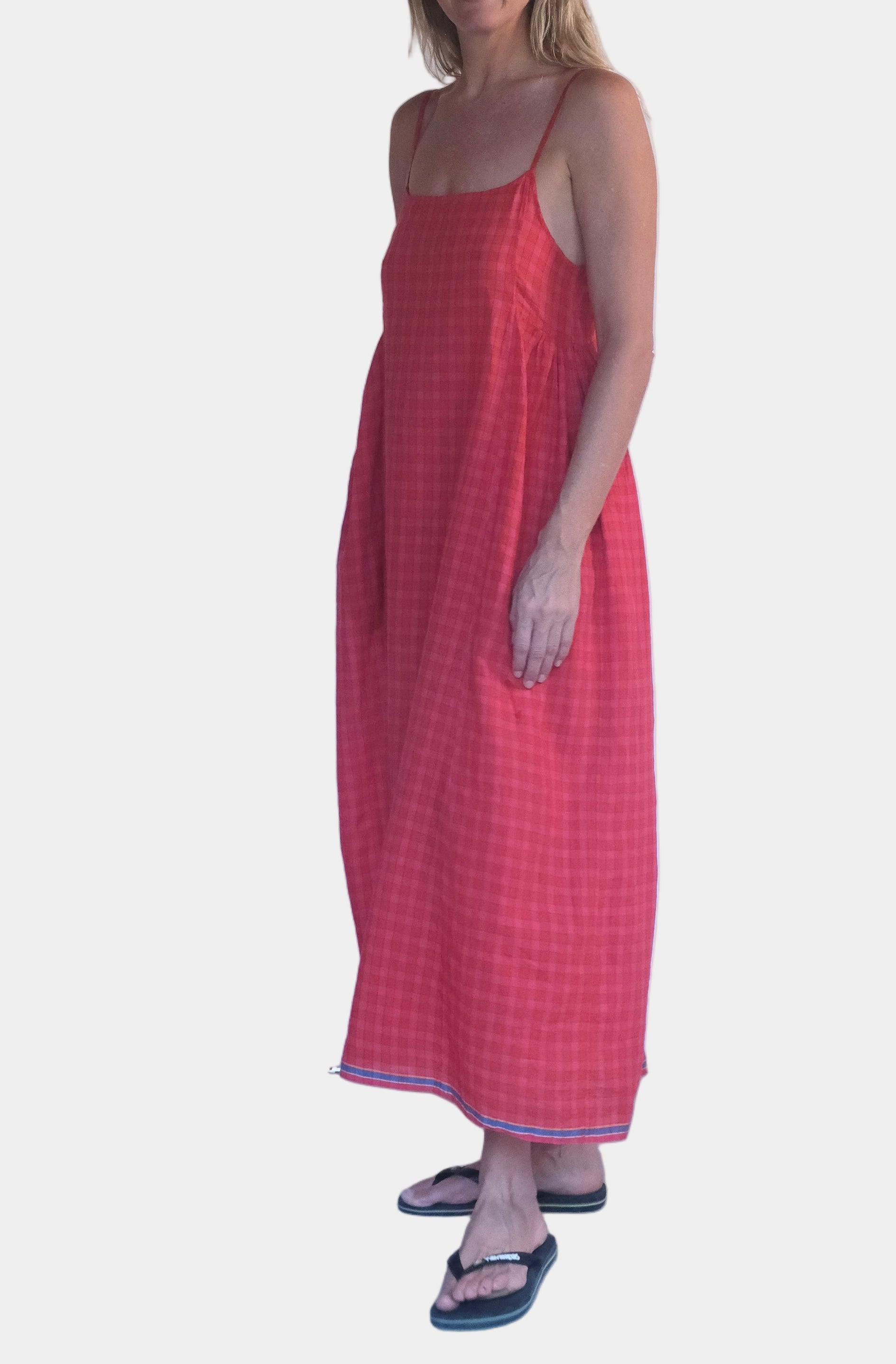 Woman wearing a red dress standing in front of a white background