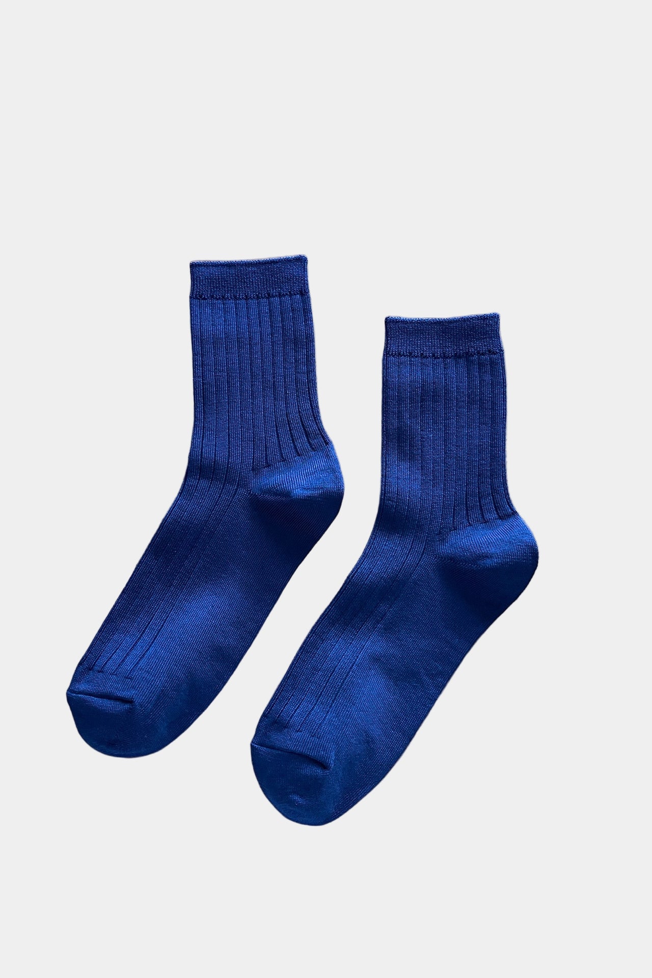 Pair of blue socks on a white background
