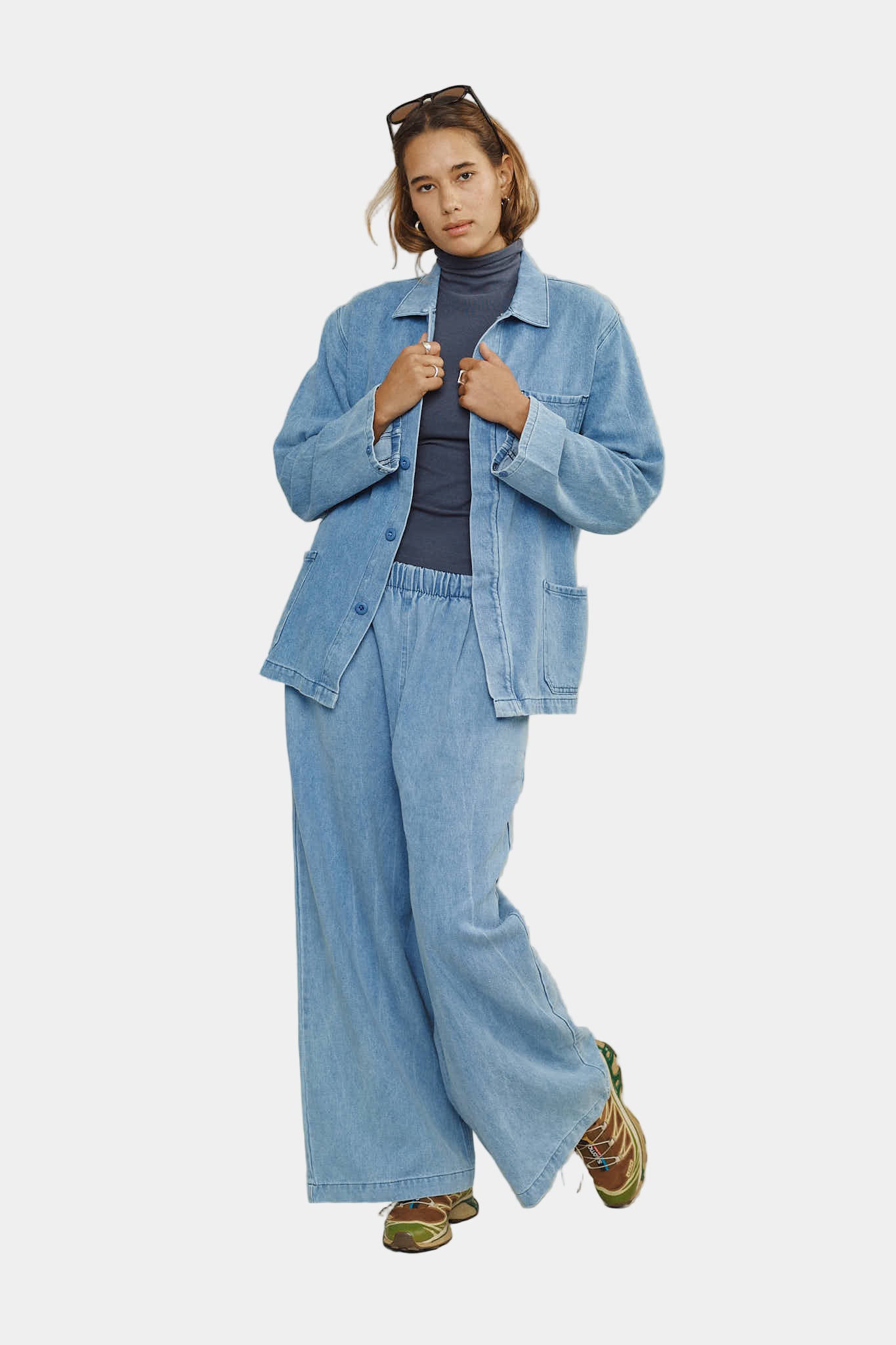 Person wearing a denim outfit on a plain background