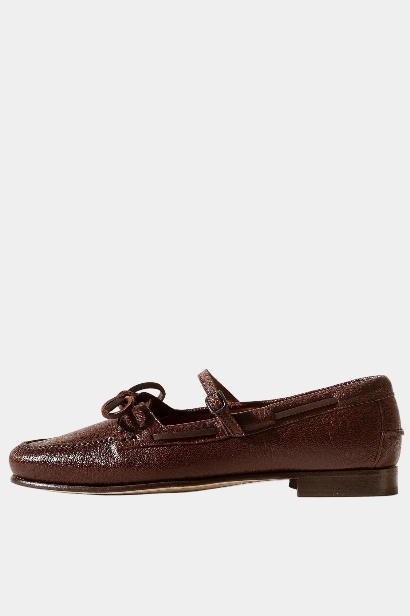 Brown leather loafer shoe on a beige background
