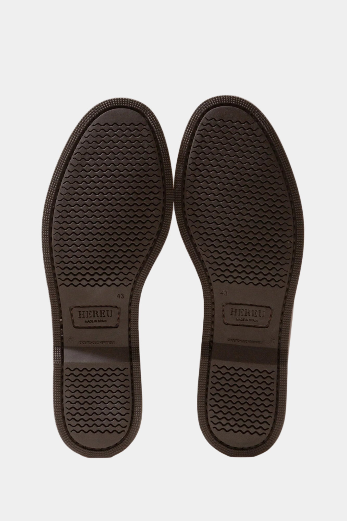 a textured sole branded with hereu, on a white background