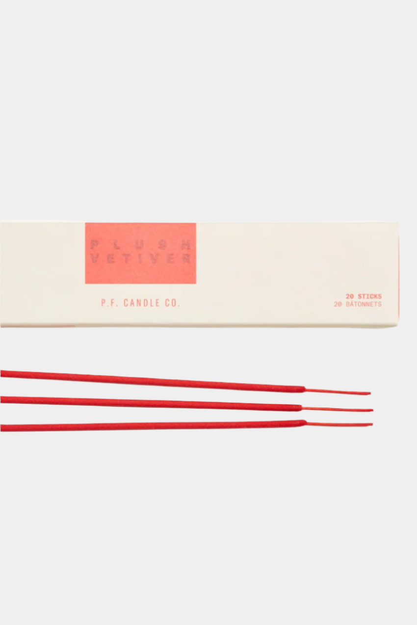 A pack of red incense sticks next to its packaging box with a minimalist design.