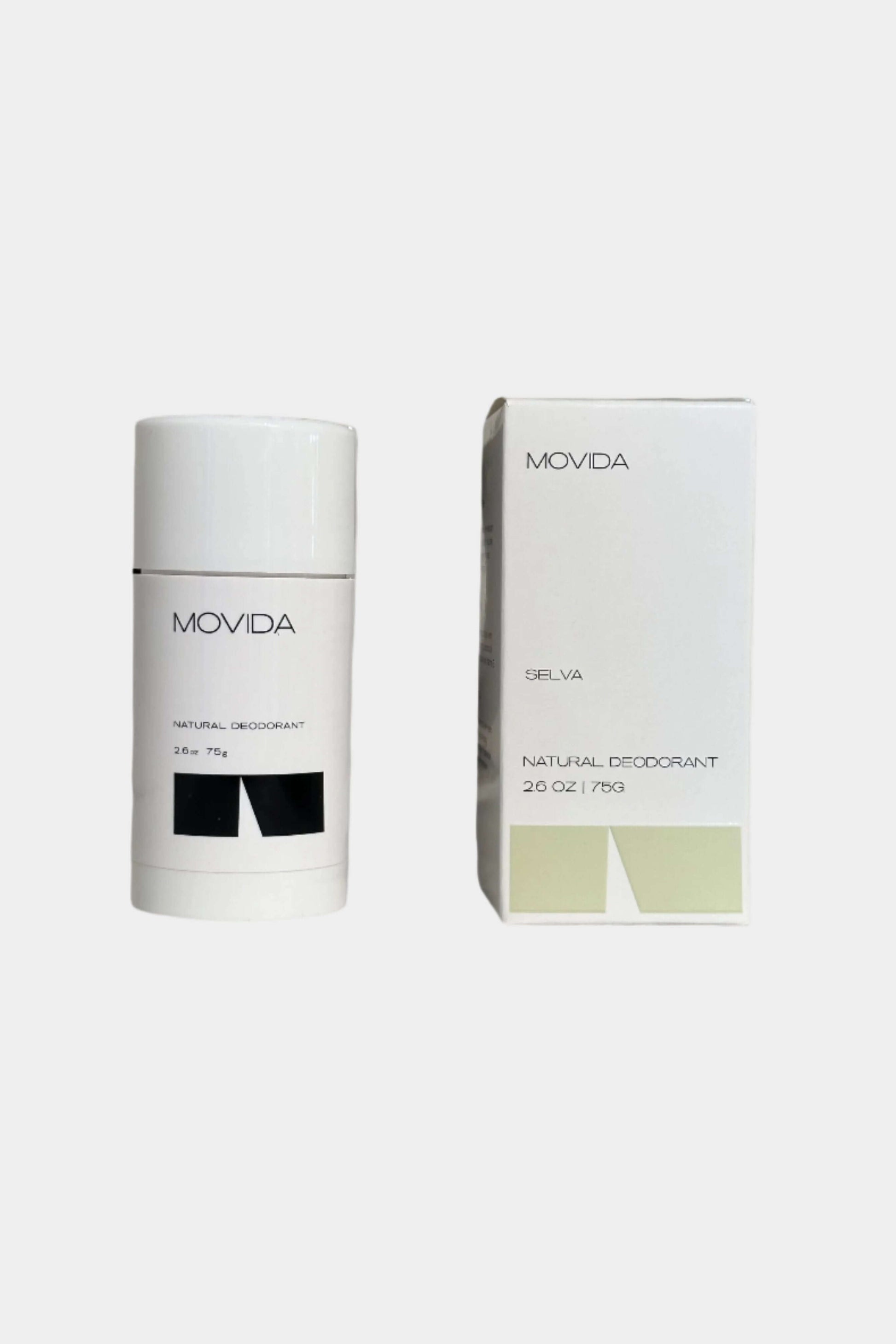 The image shows two Movida deodorant sticks, one inside the other, with the outer stick being white and the inner stick green. They are both labeled with the Movida brand name and product information.