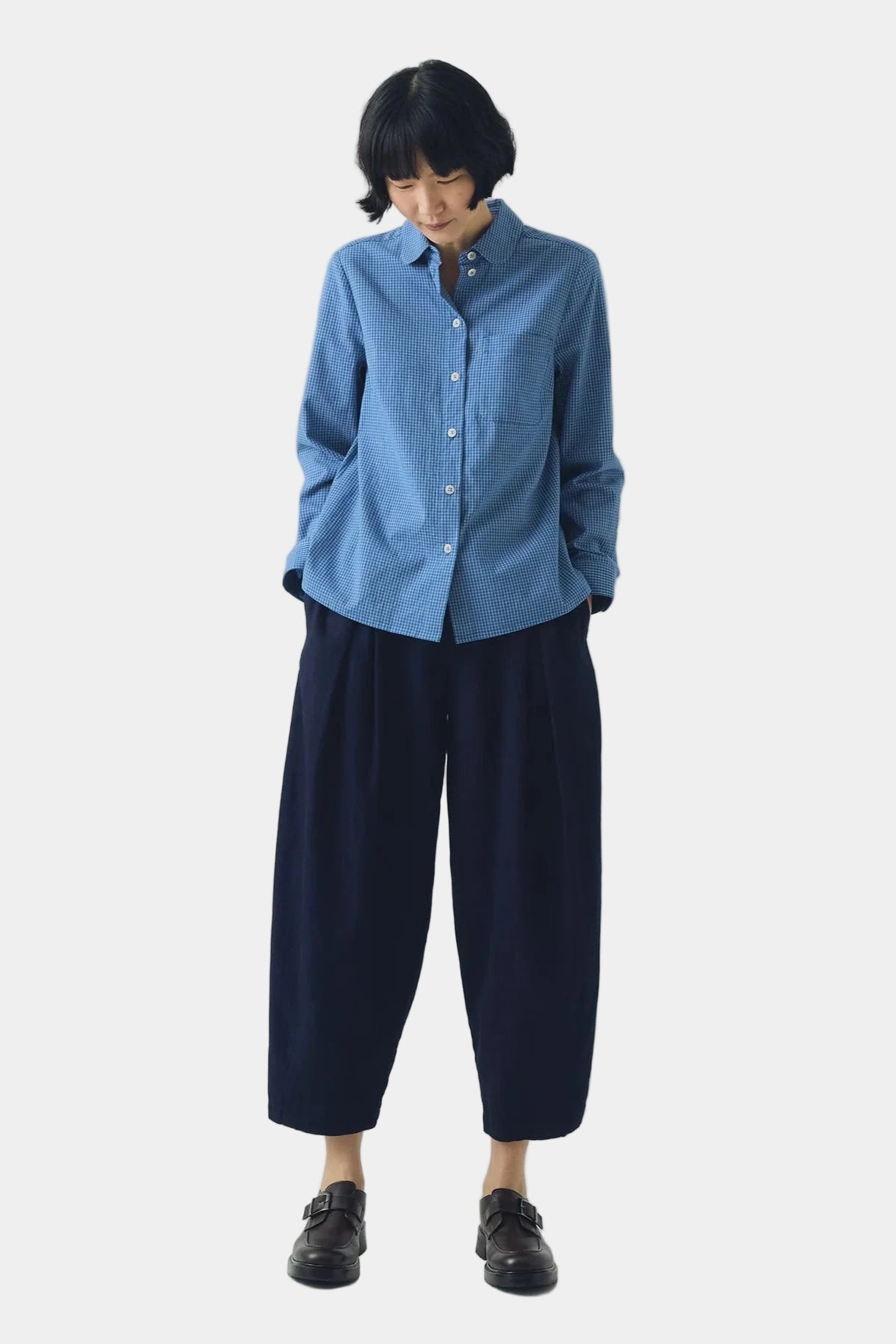 Blue checkered shirt on a light gray background