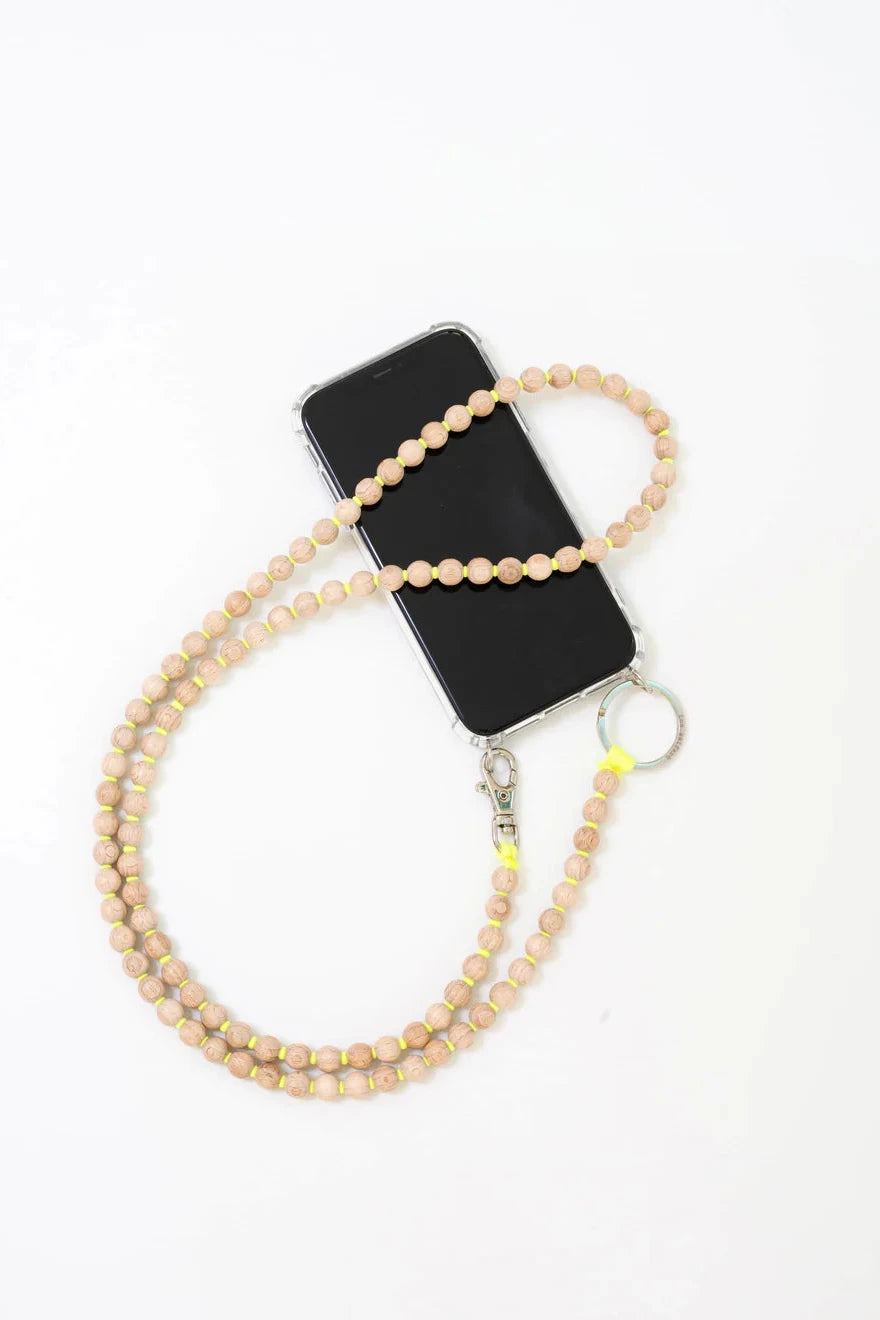 Phone with a beaded necklace on a white background