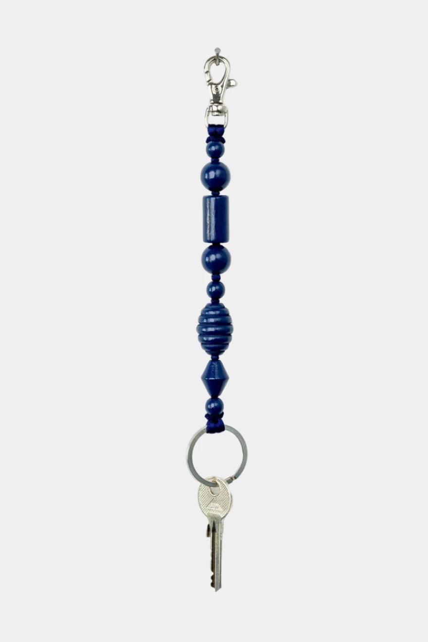 Keychain with blue beads and a key on a white background