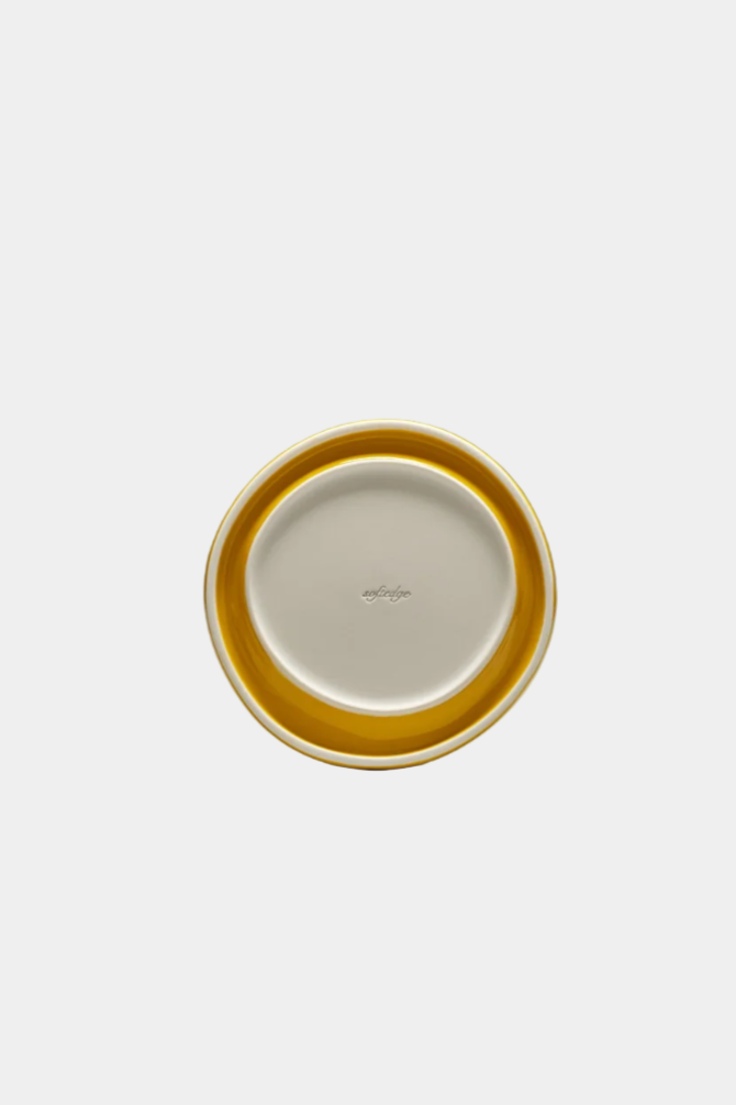 underneath view of the mustard snack plate on a white background