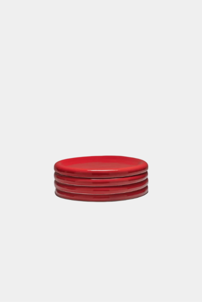 Stack of tomato red snack plates on a white background