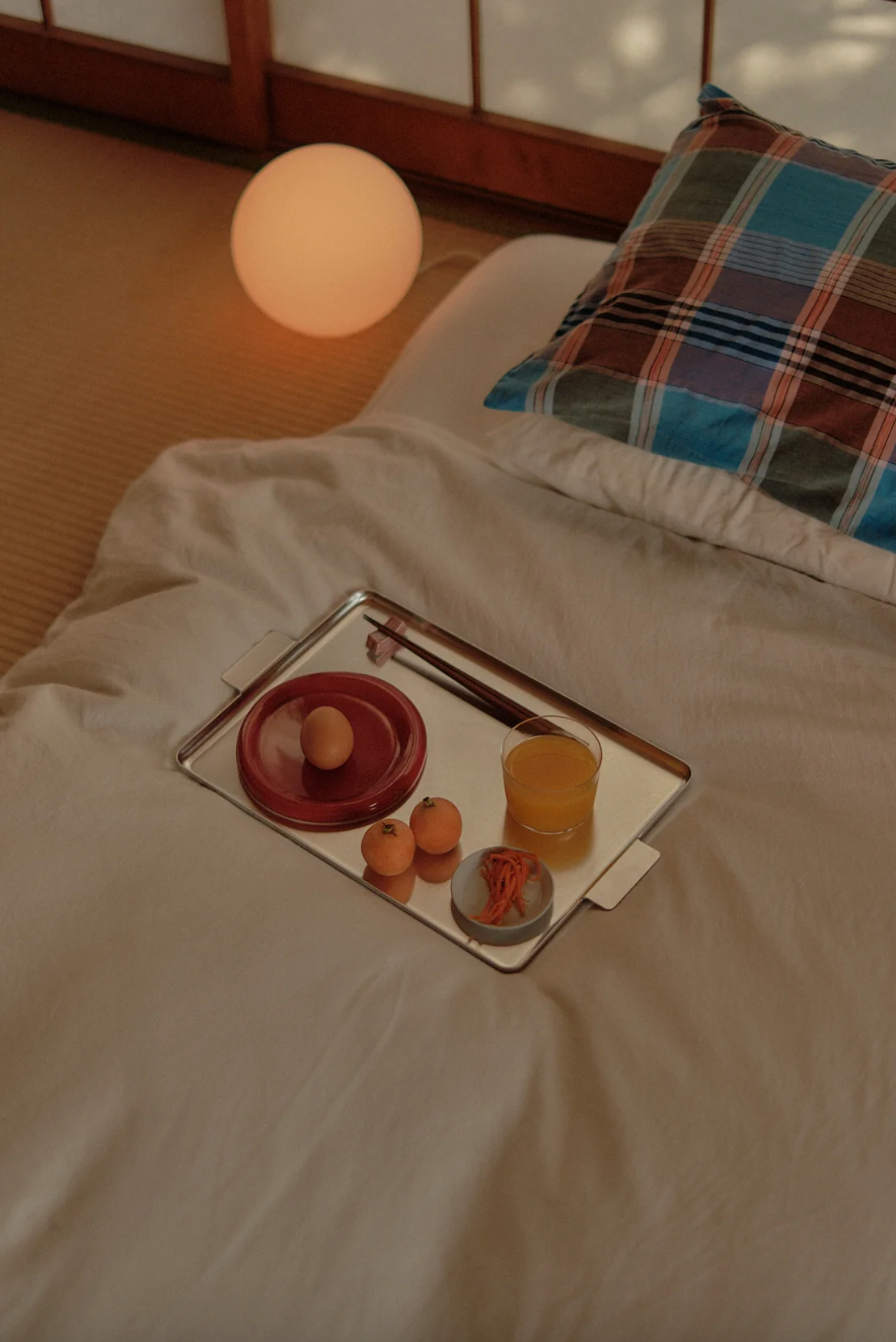 snack plate tomato on a Tray with food on a bed in a softly lit room