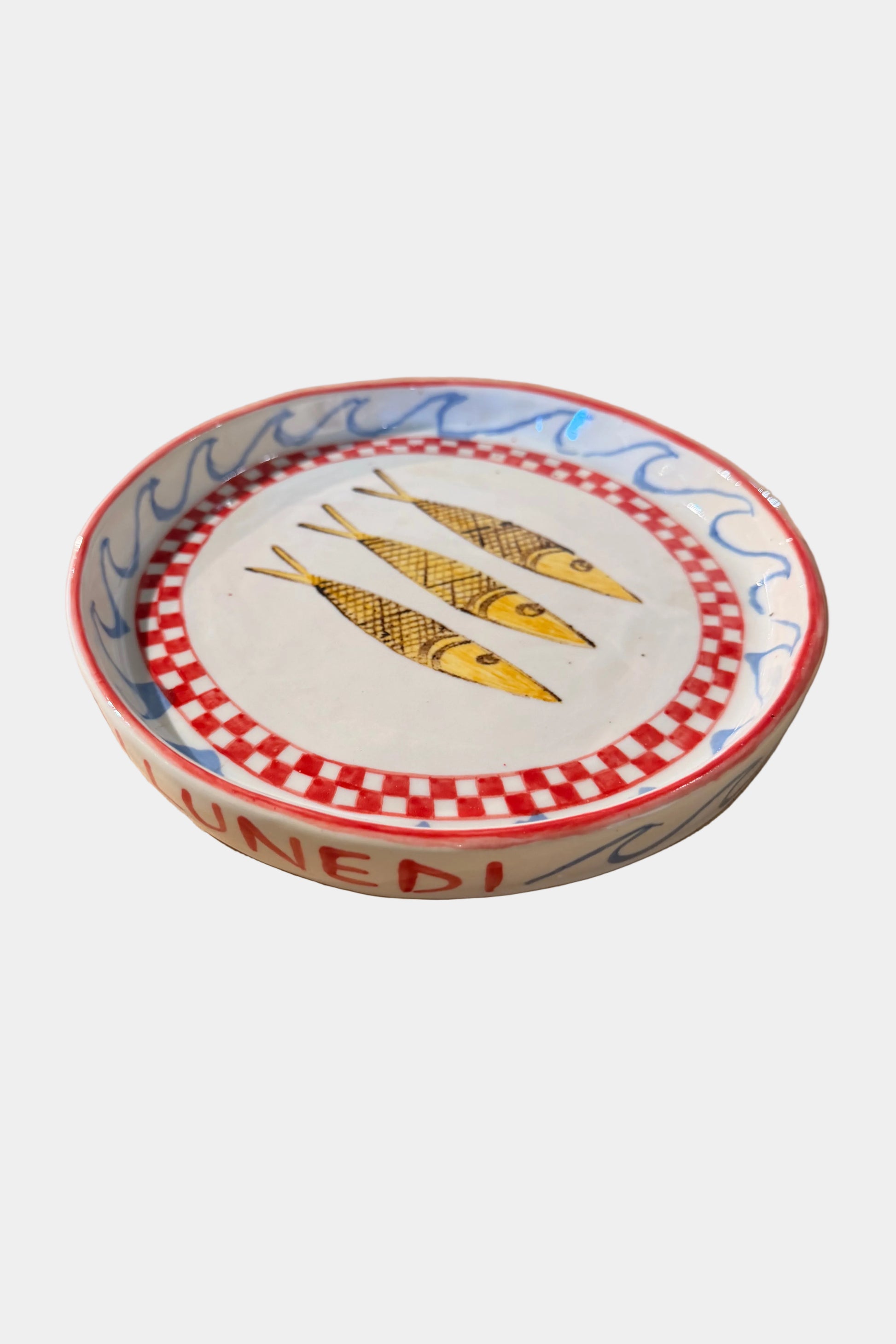 Decorative plate with fish design on a plain surface