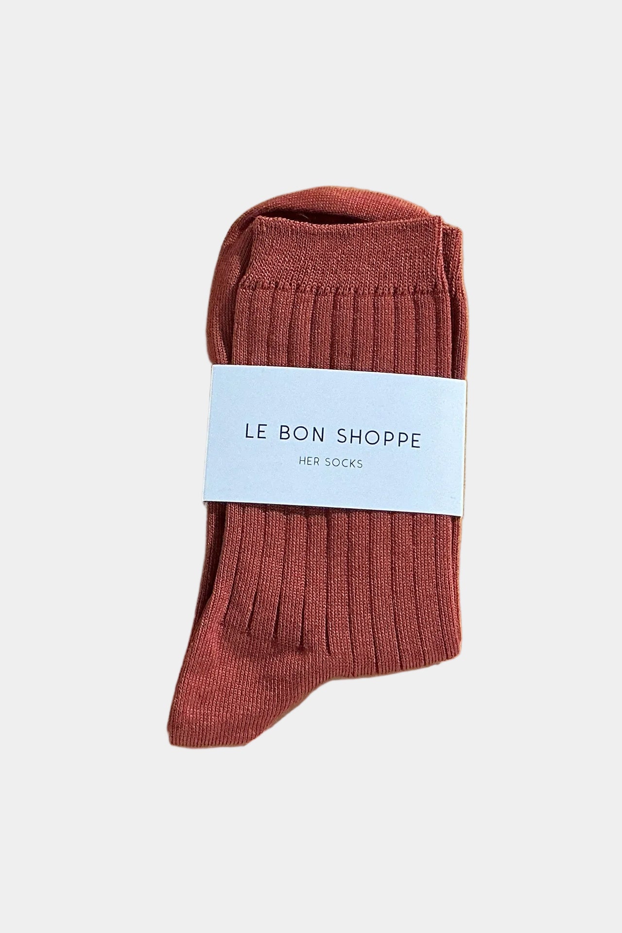 Terracotta sock with branded paper ban on a plain background