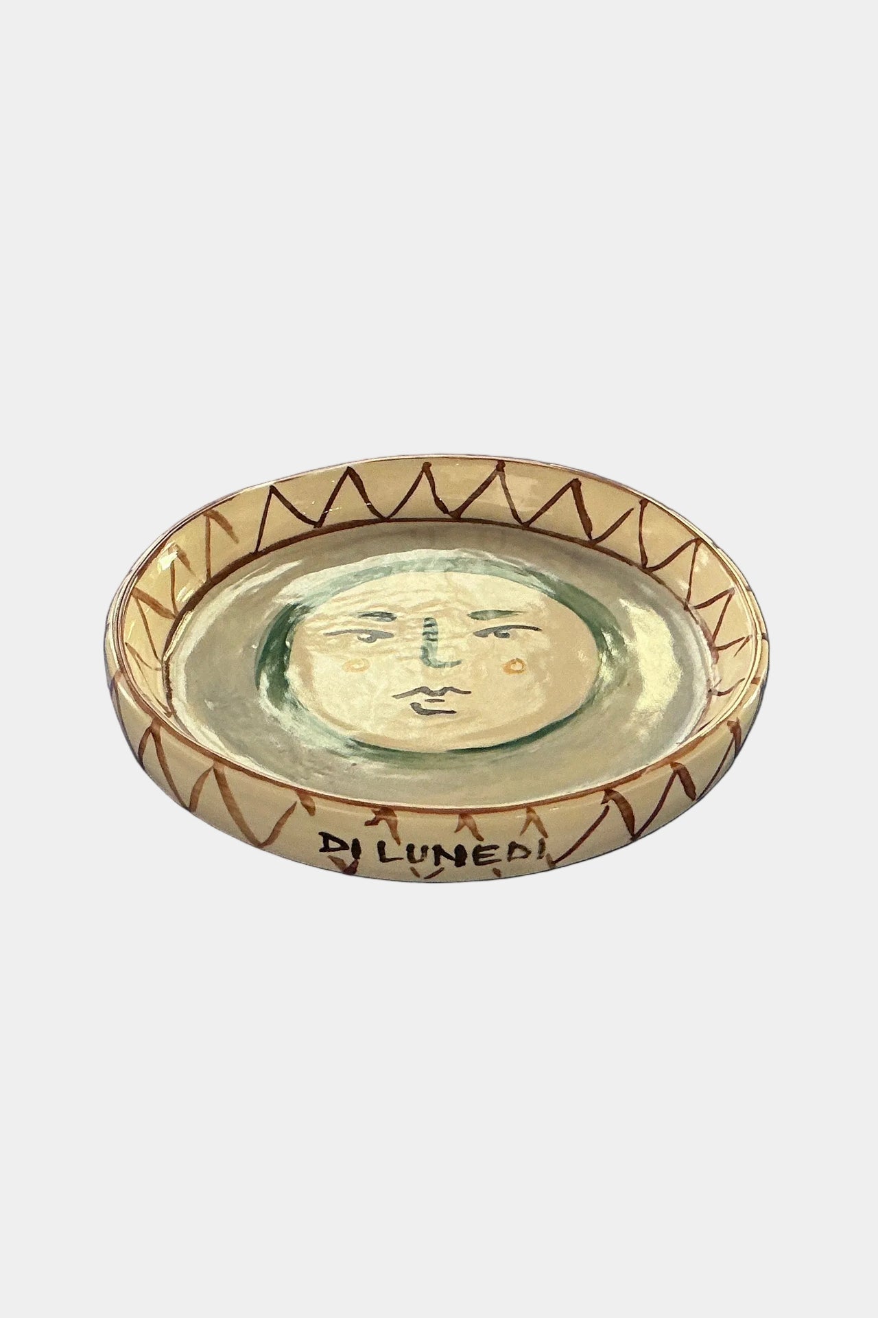 Ceramic plate with face design on a white background