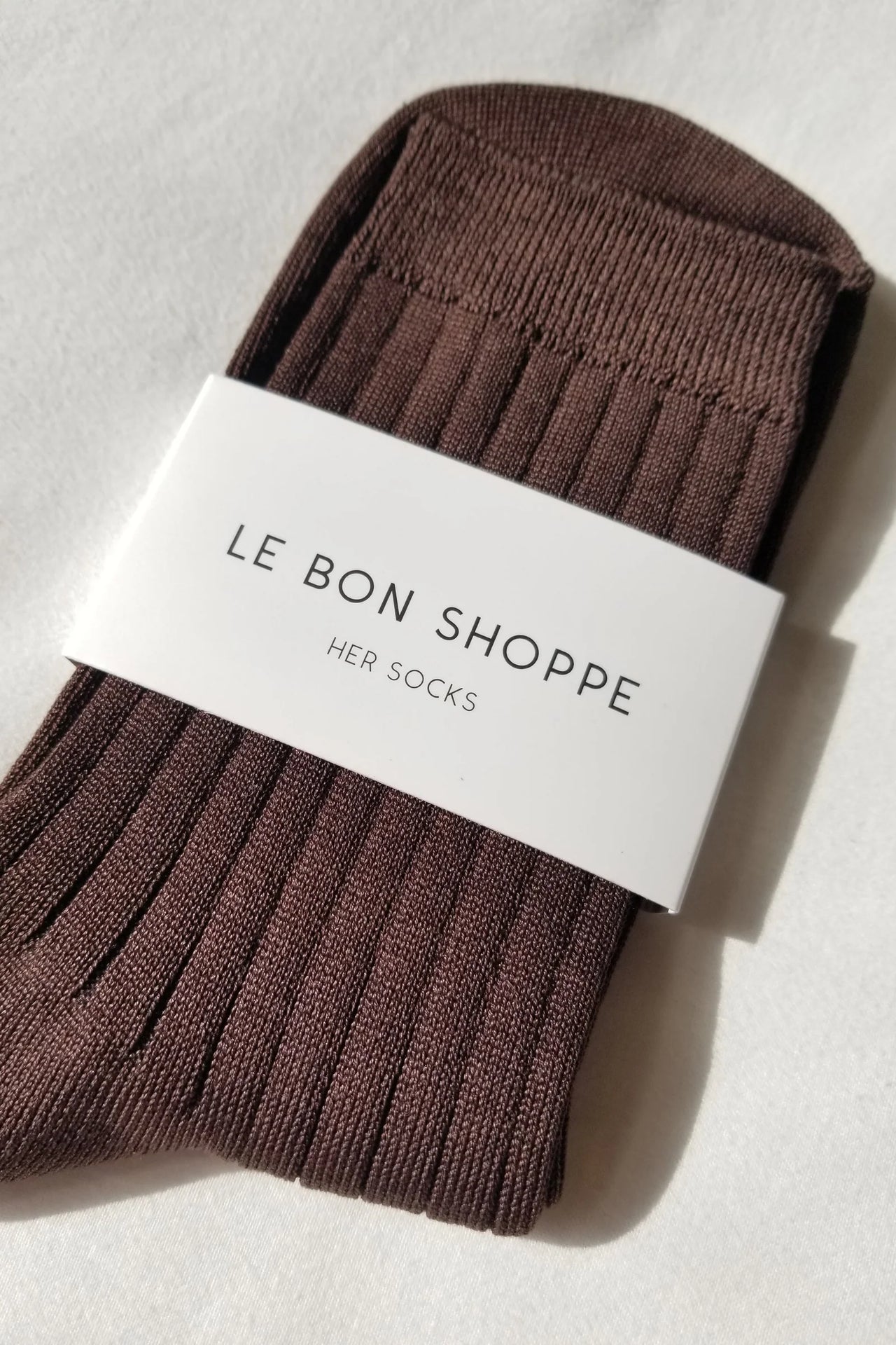 Pair of brown socks on a light gray background