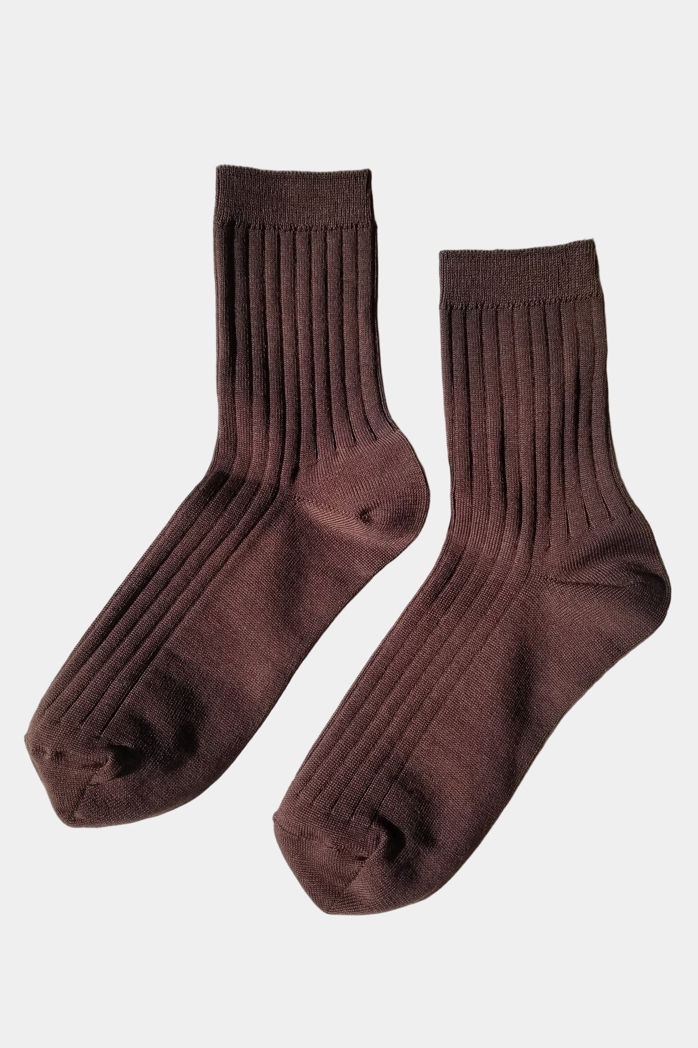 Pair of brown socks on a light gray background