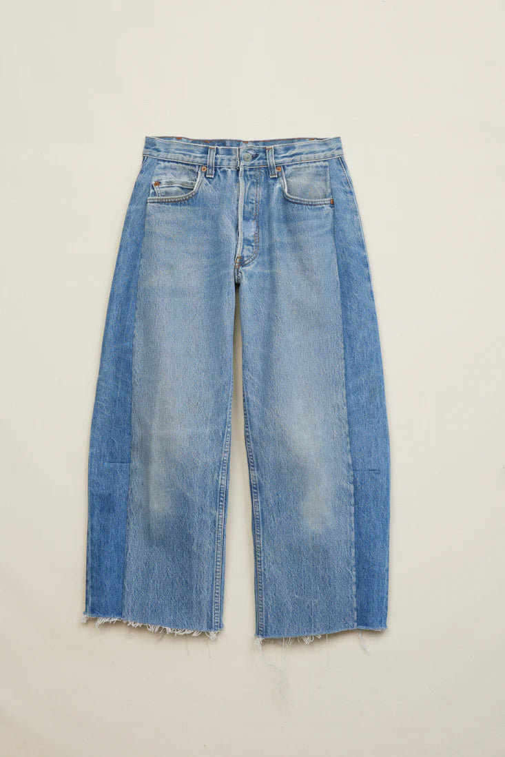 Pair of blue jeans on a light beige background