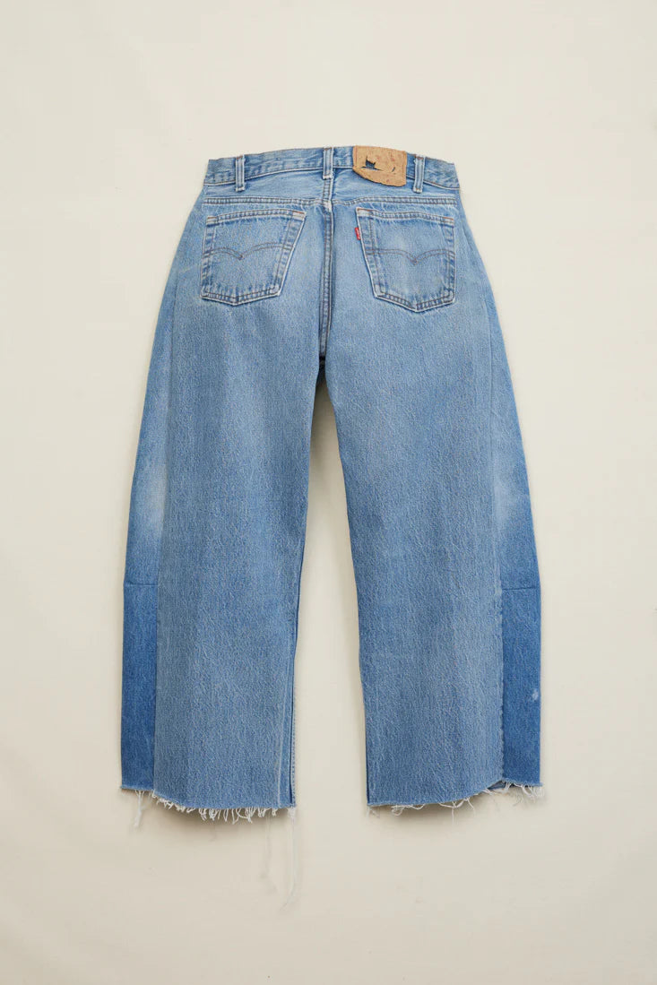 Pair of blue jeans on a beige background