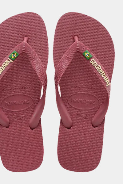 Pair of maroon flip-flops with brand logo on a light gray background