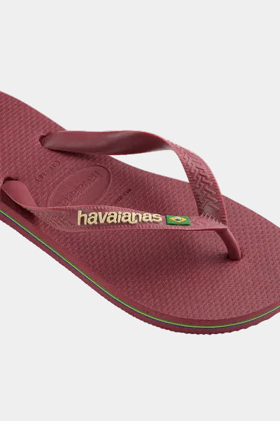 Pair of maroon flip-flops with brand logo on a light gray background