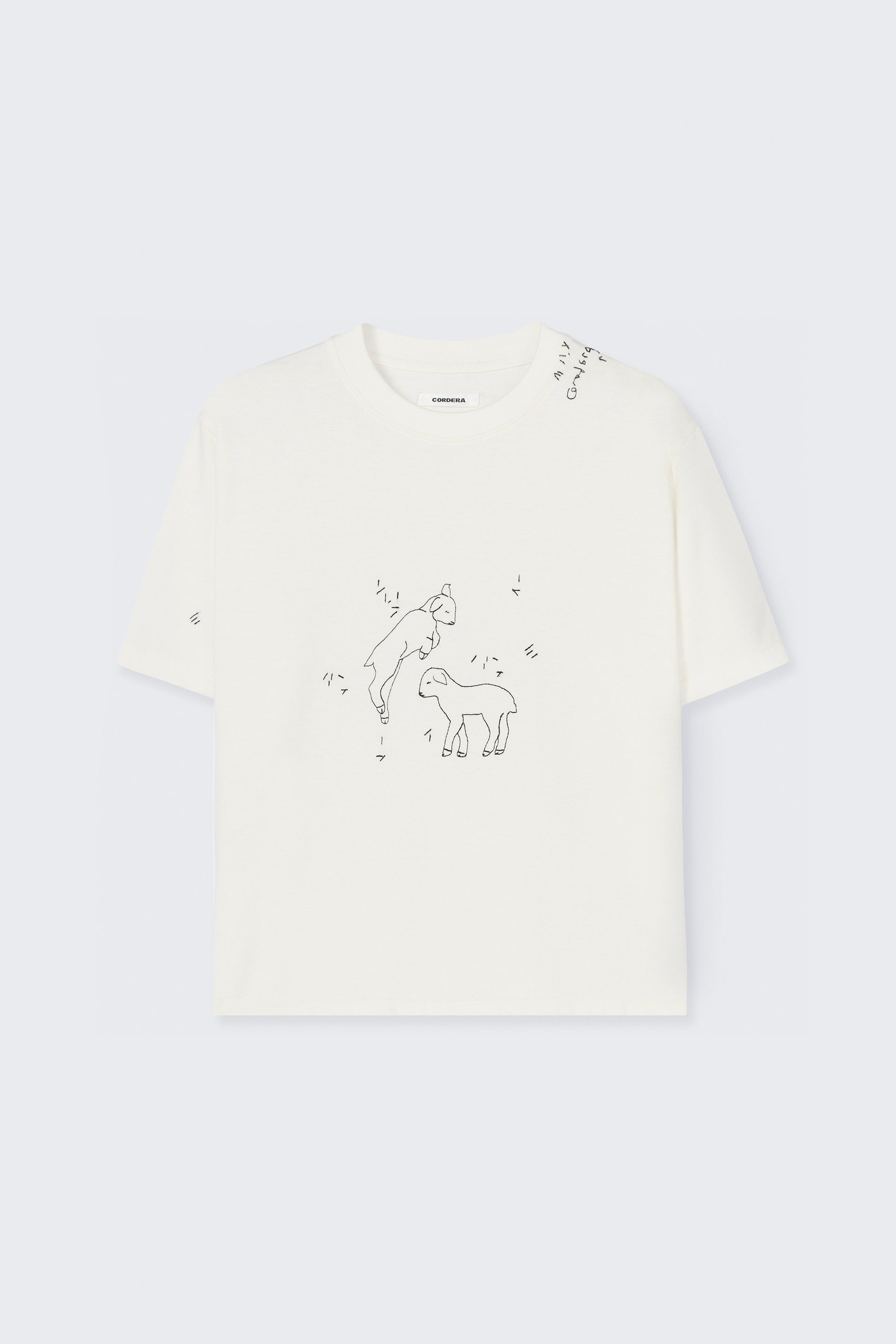 White t-shirt with embriodered lamb  design on a light gray background